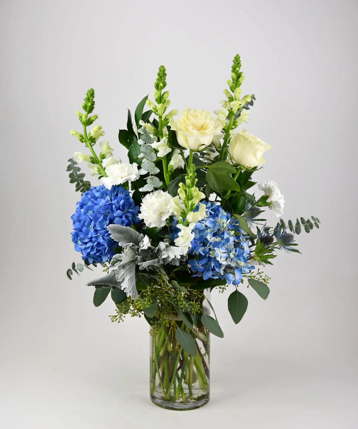 BLISSFUL BOUQUET - This heavenly arrangement of white flowers with blue accent blooms sends a message of blissful love.