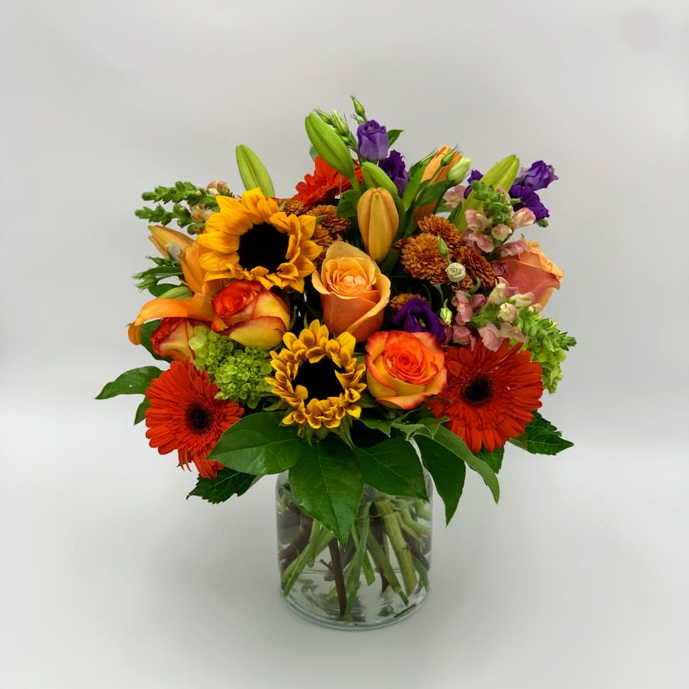 Happy Mixed Bouquet  - This a bright and colorful bouquet that bring joy and a big smile with yellow fresh Floridian sunflowers orange bright roses orange gerberas bright and beautiful lilies and other filler flowers to fill the bouquet with volume. 