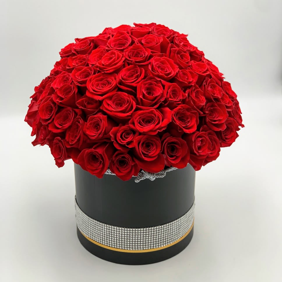 Empire - a high-quality luxury arrangement for a special occasion adorned with 100 fresh beautiful high-quality roses in a black round box with a bedazzled silver ribbon.