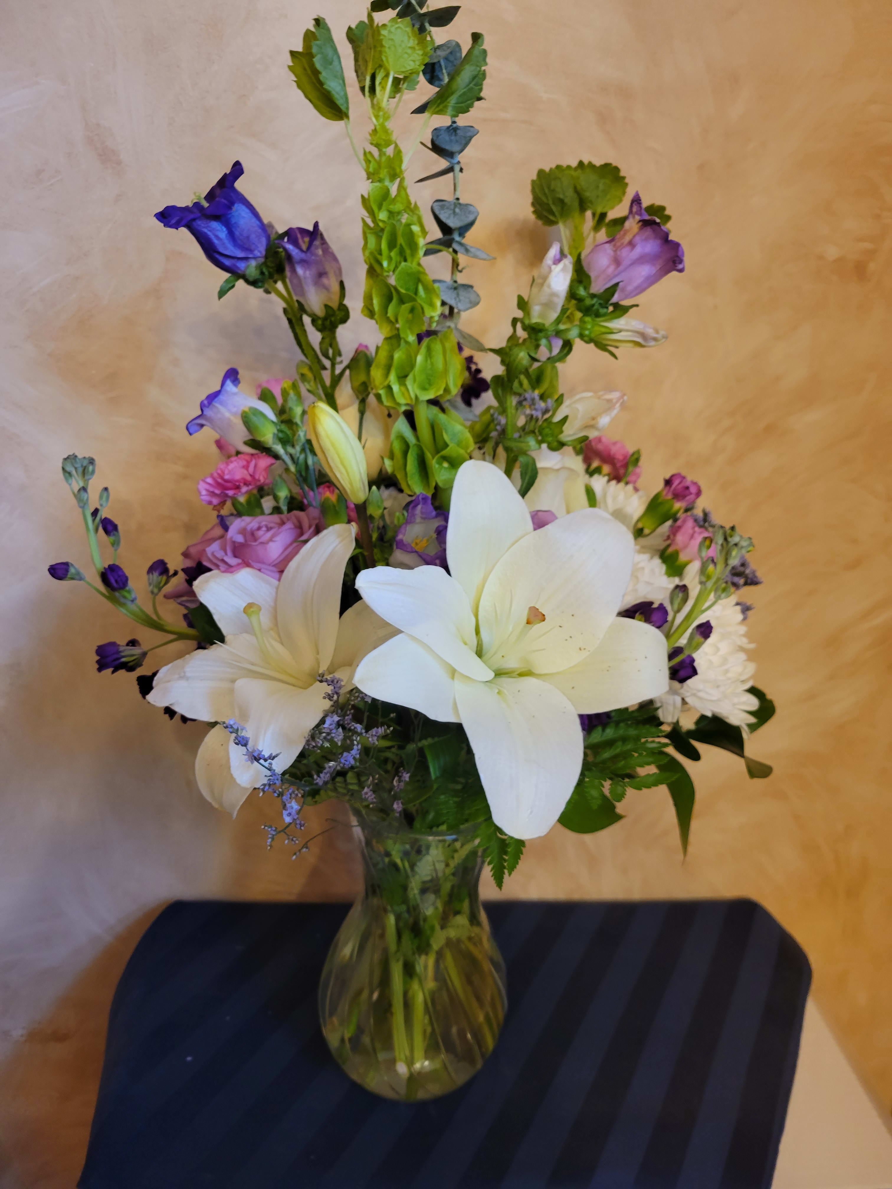 Pure Mom - Big and fragrant Star Gazer Lillies compliment the garden florals in this pretty mixed bouquet