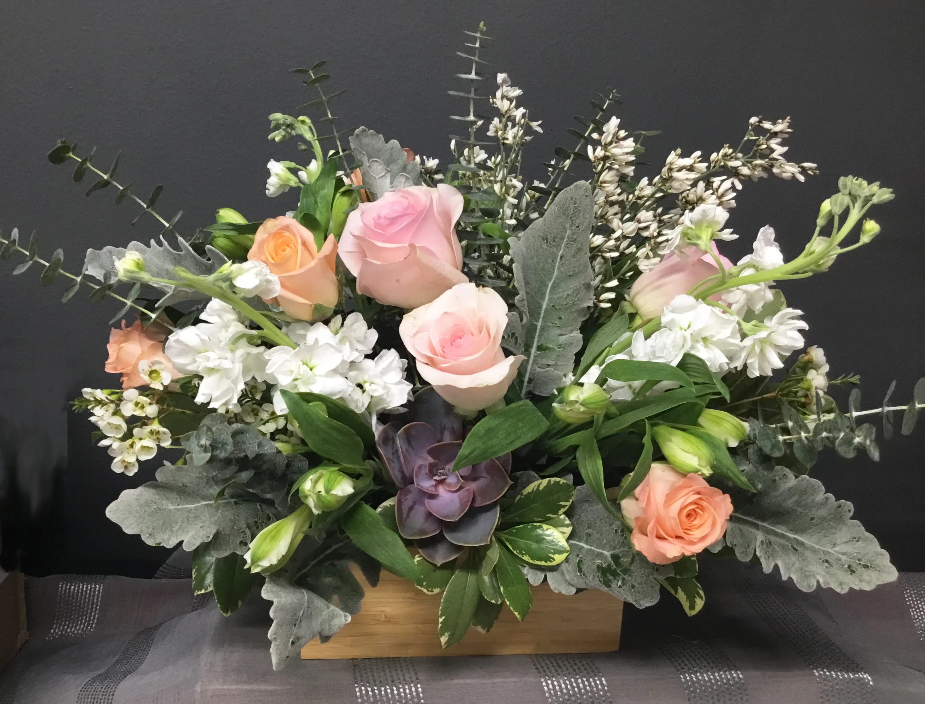Wild Beauty - Mixed greens and pastel roses with stock and a succulent