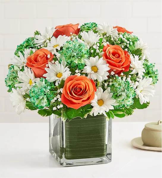 Irish Blessing Bouquet Irish Blessing Bouquet - Our classic St. Patrick’s Day bouquet is full of blessings for family & friends. Gathered with a mix of blooms in the colors of the Irish flag, this compact arrangement is a wonderful way to celebrate their heritage, while reminding them how lucky you are to have them in your life. All-around arrangement with orange roses, dyed green carnations and white daisy poms; accented with baby’s breath and assorted greenery Artistically designed in a clear glass cube with Ti leaf ribbon