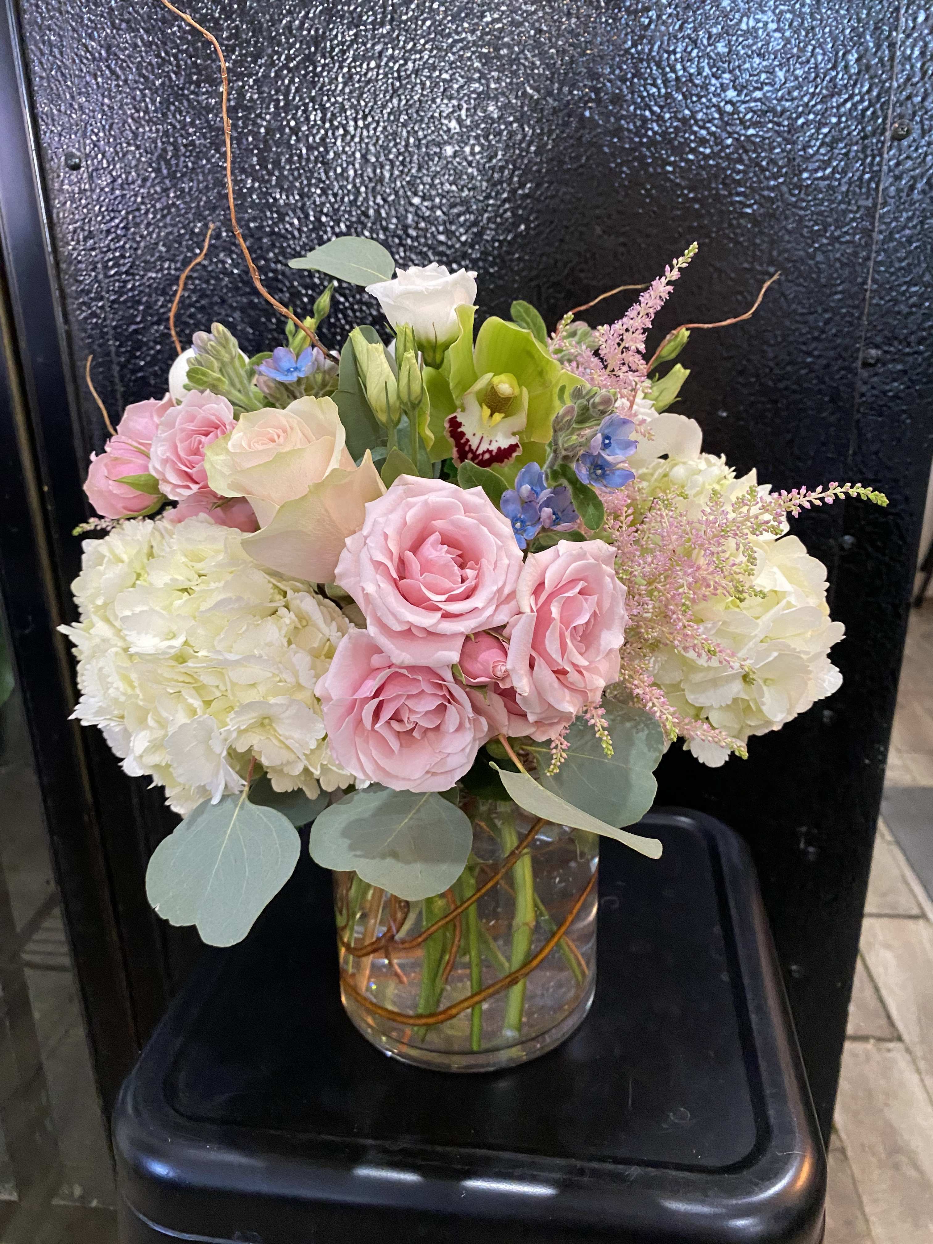 Ballerina  - hydrangeas, roses, spray roses, lisianthus, green cymbidium and curly willow   Delivery minimum is $50.00 Our DELIVERY SERVICE IS TILL 3 PM We cannot guarantee requests for a specific time of delivery. There might be flower substitutions, due to low supply of certain flowers. However, we do our best to provide you with the same look and feel of the arrangement. Our main goal is to always give our customers quality flowers and service. To make sure that you get the exact same flowers, ordering a few days ahead of desired delivery date is key.