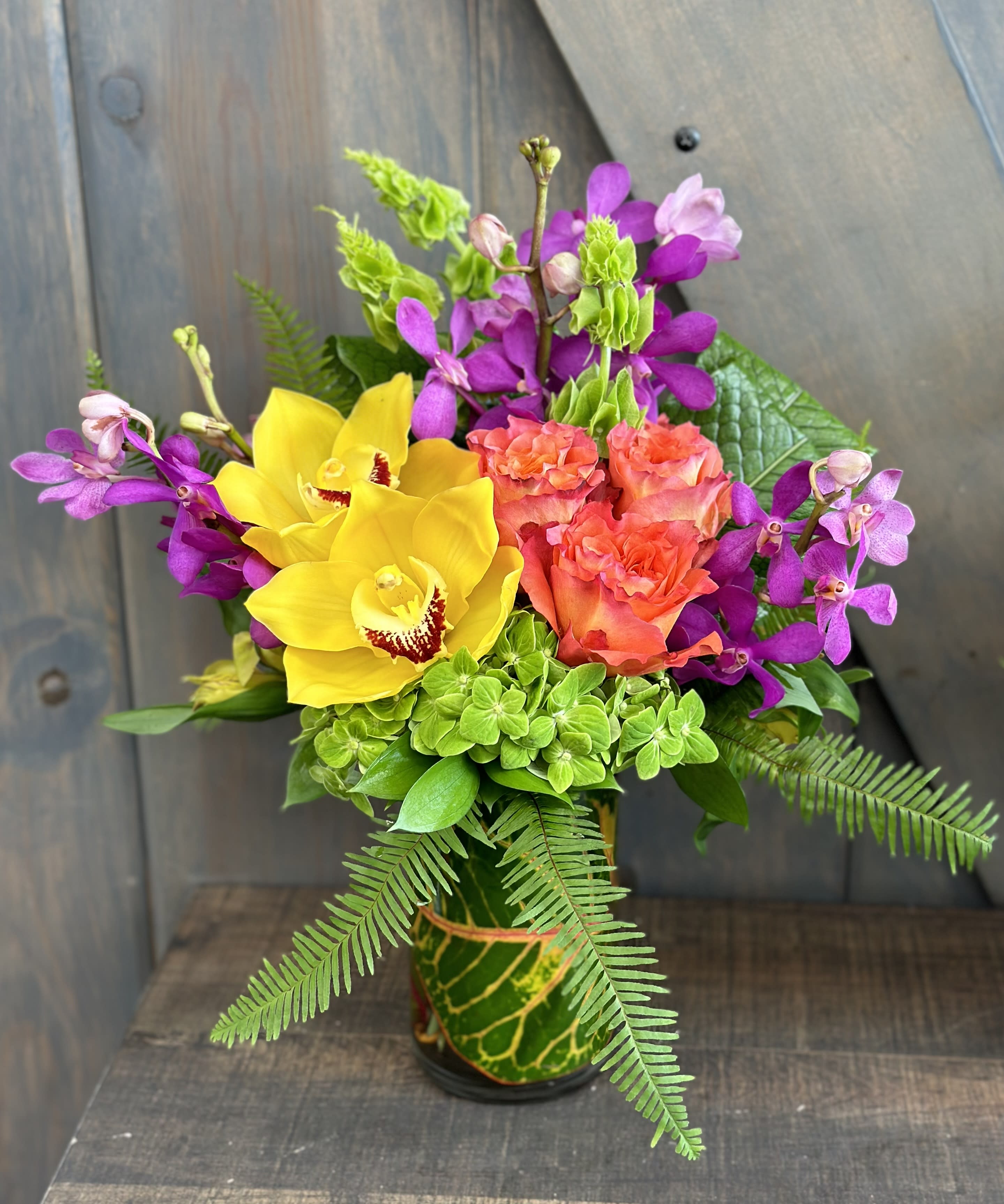 Mini Vacay! - Mini Vacay this weekend? We have the perfect arrangement for your getaway. Flowers included in this design are Roses, Mokara Orchids, Cymbidium orchids, Hydrangea, Bells of Ireland, Alstroemeria, and Tropical foliage