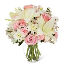 Lovely Lily and Pink Roses - This beautiful bouquet is created with a white oriental lily, white alstromeria, white cushion daisies, pink mini carnation and pink roses.
