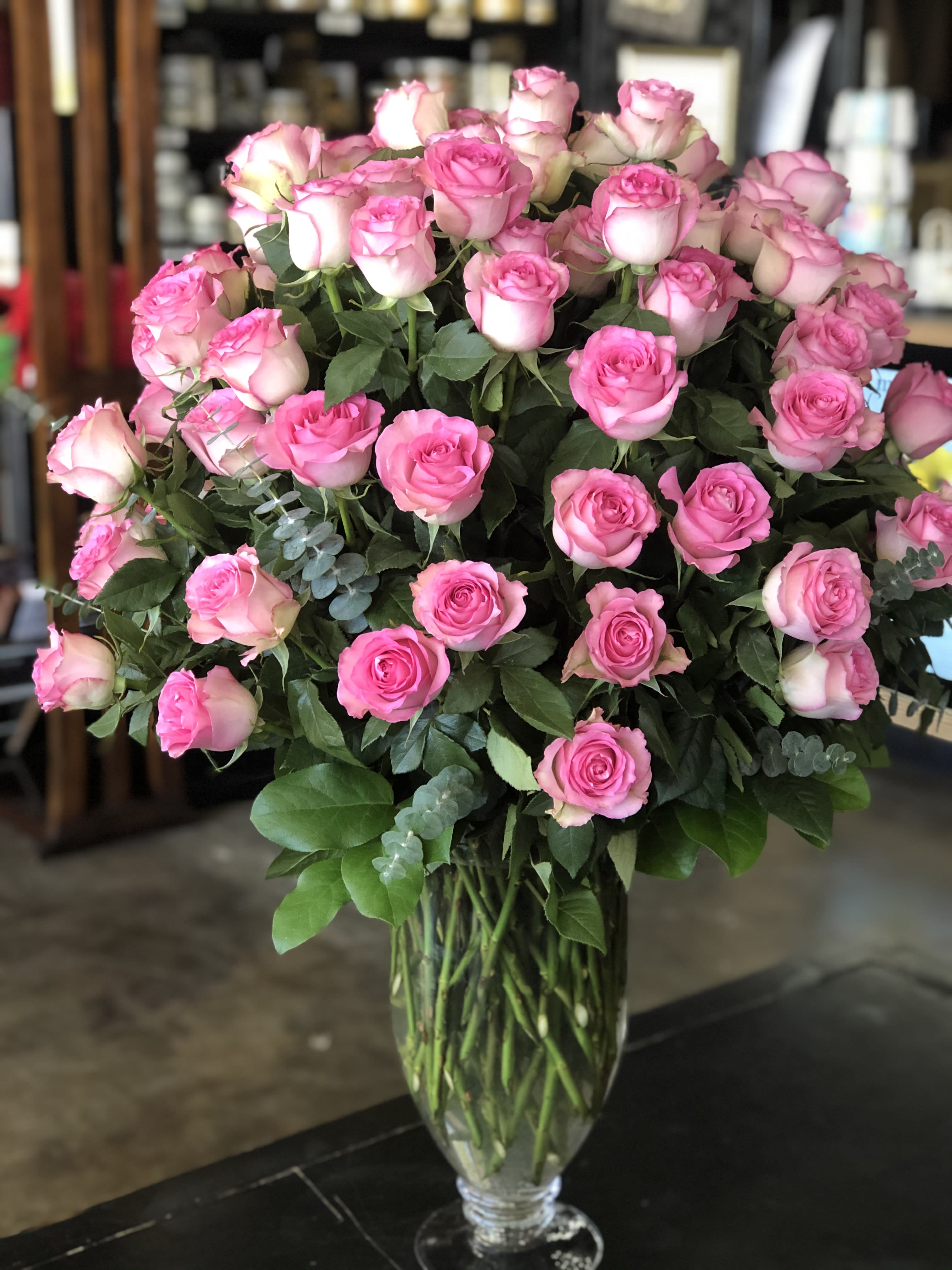100 Pink Roses - 100 pink roses with mixed greenery in beautiful vase. Vase  depends on what we have in stock and if you want another color please specify in notes.   MUST BE ORDERED 24 HOURS IN ADVANCE OF DELIVERY DATE TO ENSURE WE CAN GET FLOWERS.