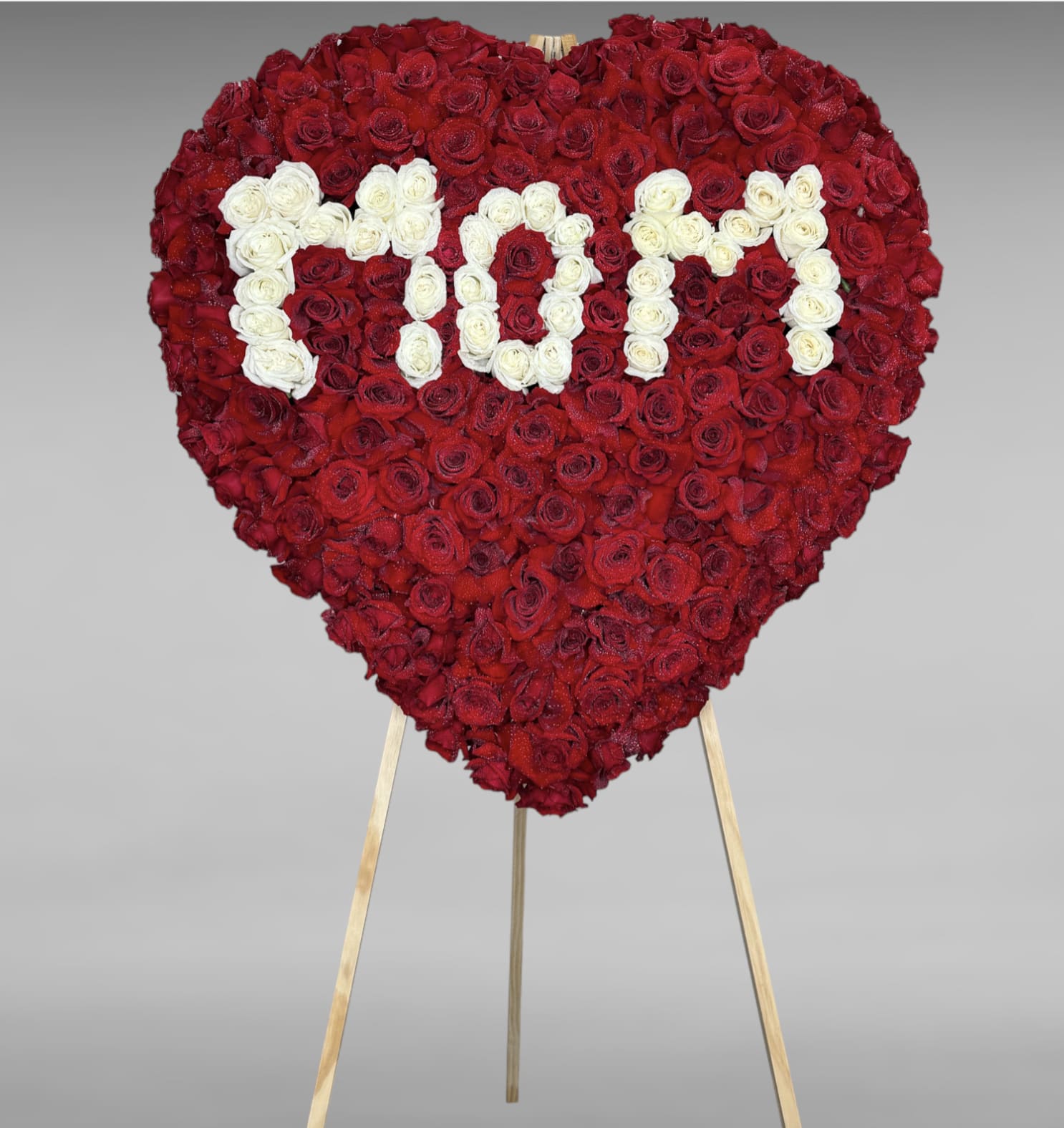 Loving Remembrance  - Their pure heart and peaceful spirit will live on in a gesture symbolizing the heart of eternal life. Our standing heart of soothing white roses and fresh red roses, expertly crafted by our florists for a lush, full presentation, is a grand expression of your condolences, offering hope and serenity during a difficult time. All-white standing heart arrangement with white roses and red roses.
