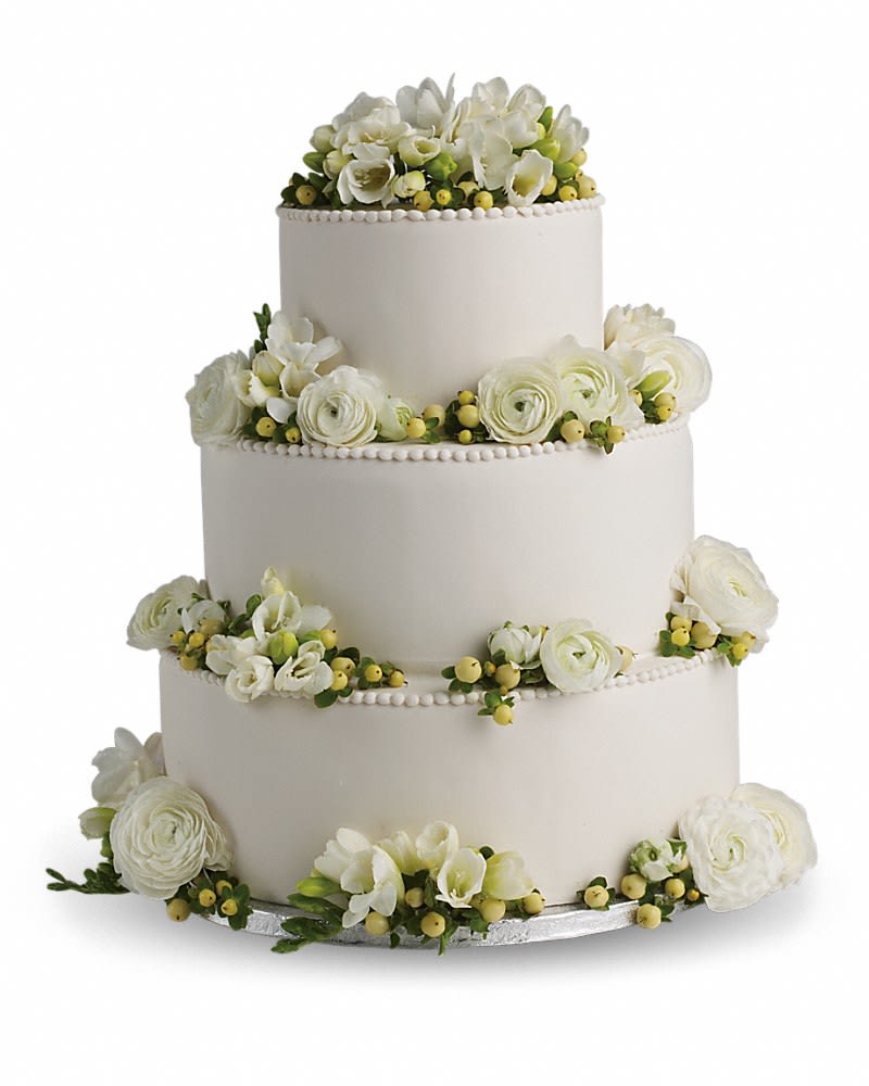 Freesia and Ranunculus Cake Decoration - Fragrant snow white blooms and green berries add soft natural beauty to your cake. Stems of white freesia and ranunculus are set off against yellow hypericum.