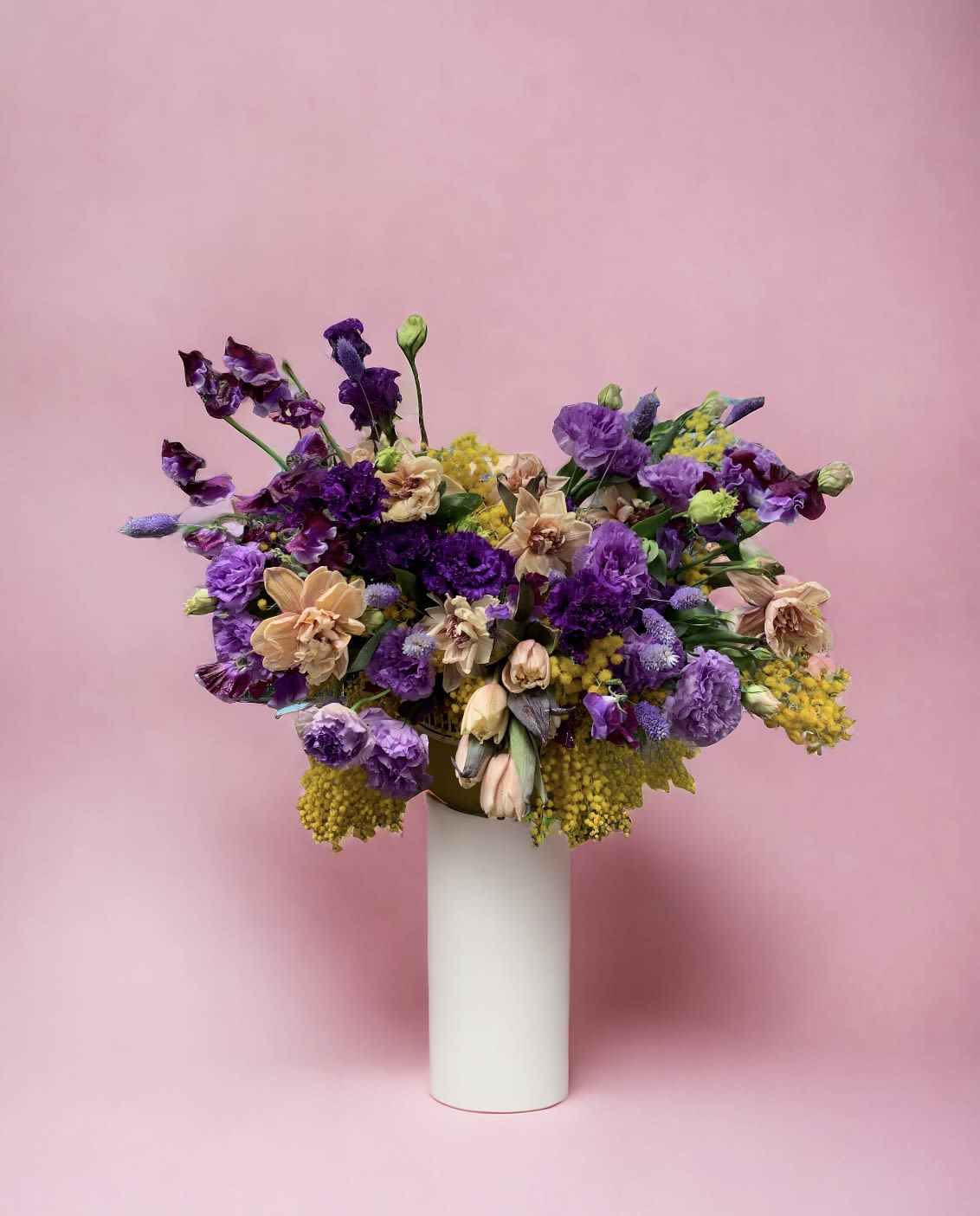 Purple lover Purple lover - Take in the spring season with your favorite shades of purple and yellow& peach. Flower: Peach tulips and soft yellow green are placed amongst purple Lisianthus and seet peacontrasting the dark purple sweet pea. overall this arrangement stands around 20” tall overall. Vase : H 12 * W 6 white clear vase