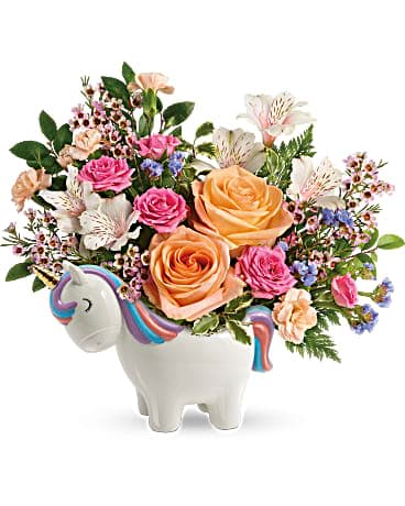 Teleflora's Magical Garden Unicorn Bouquet Teleflora's Magical Garden Unicorn Bouquet - Nothing's sweeter than this delicate and magical rose bouquet, carefully arranged in this charming, hand-painted ceramic unicorn keepsake! Peach roses, pink spray roses, white alstroemeria, peach miniature carnations, blue sinuata statice, and pink waxflower are accented with huckleberry and pitta negra. Delivered in a Charmed Unicorn Keepsake.