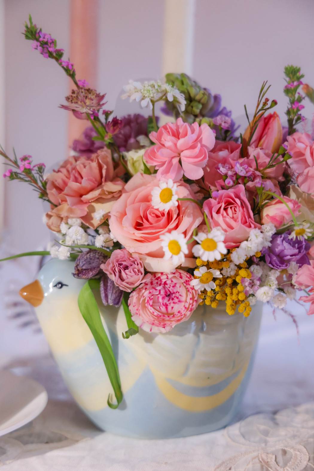 Mother Hen Arrangement - A sweet mother hen carries a Spring filled floral arrangement delight. Brighten your Mama's smile with this lovely gift and centerpiece. One of a kind by floral designer Stacy Leafsong Arrangements will be delivered by 7pm, for a specific delivery time please include in special instructions. On holidays, our busiest times, deliveries will be made by 7:30pm.