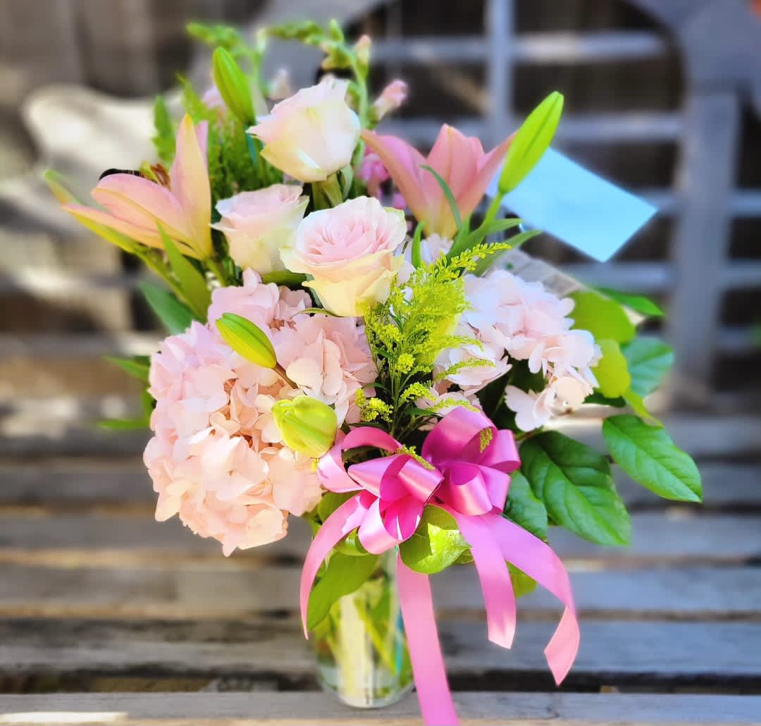 Just For You - A budget friendly yet upscale look designed in an asymmetrical style and featuring light and uplifting pastel pinks. This design contains pink hydrangeas, pink lilies, and pink roses!
