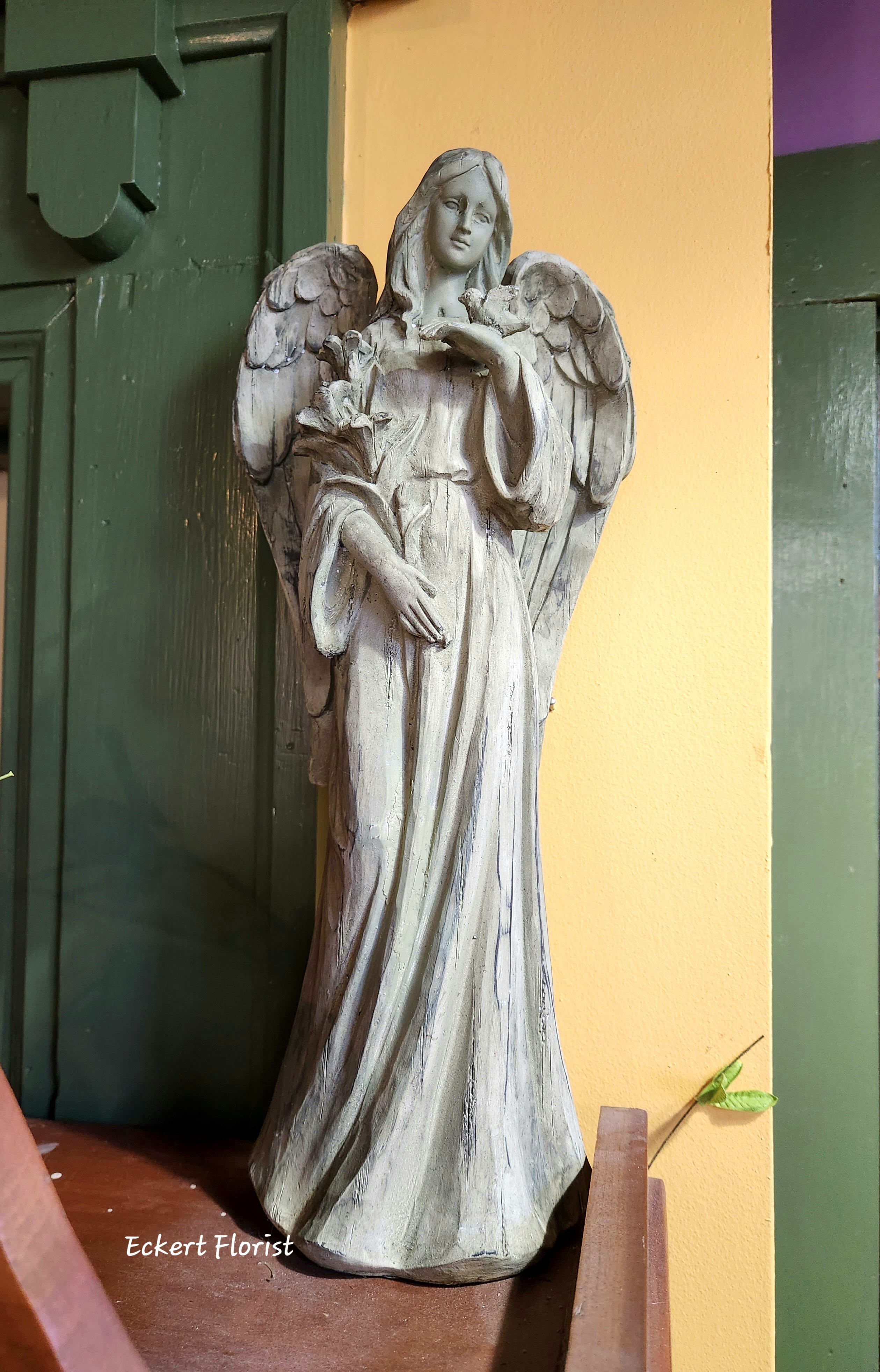Eckert Florist's Standing Angel With Bird #1 Eckert Florist's Standing Angel With Bird #1 - This resin material green angel measures approx. 16" H x 6.5" W May be added to a fresh arrangement or plant. See Deluxe and/or Premium upgrades. *OUR LOCAL DELIVERY ONLY