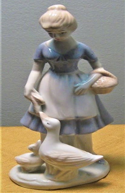 Vintage Simson Ceramic / Lady Feeding Geese Vintage Simson Ceramic / Lady Feeding Geese - Vintage piece by Simson. Done is pastel blue and white, this piece stands approximately 9" high and is in perfect condition.