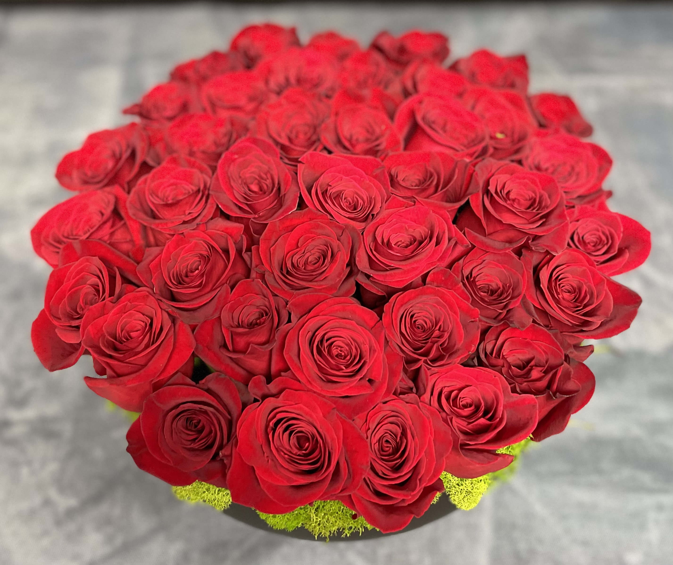 Moulin Rouge - 40 stems of red roses with chic black ceramic container.