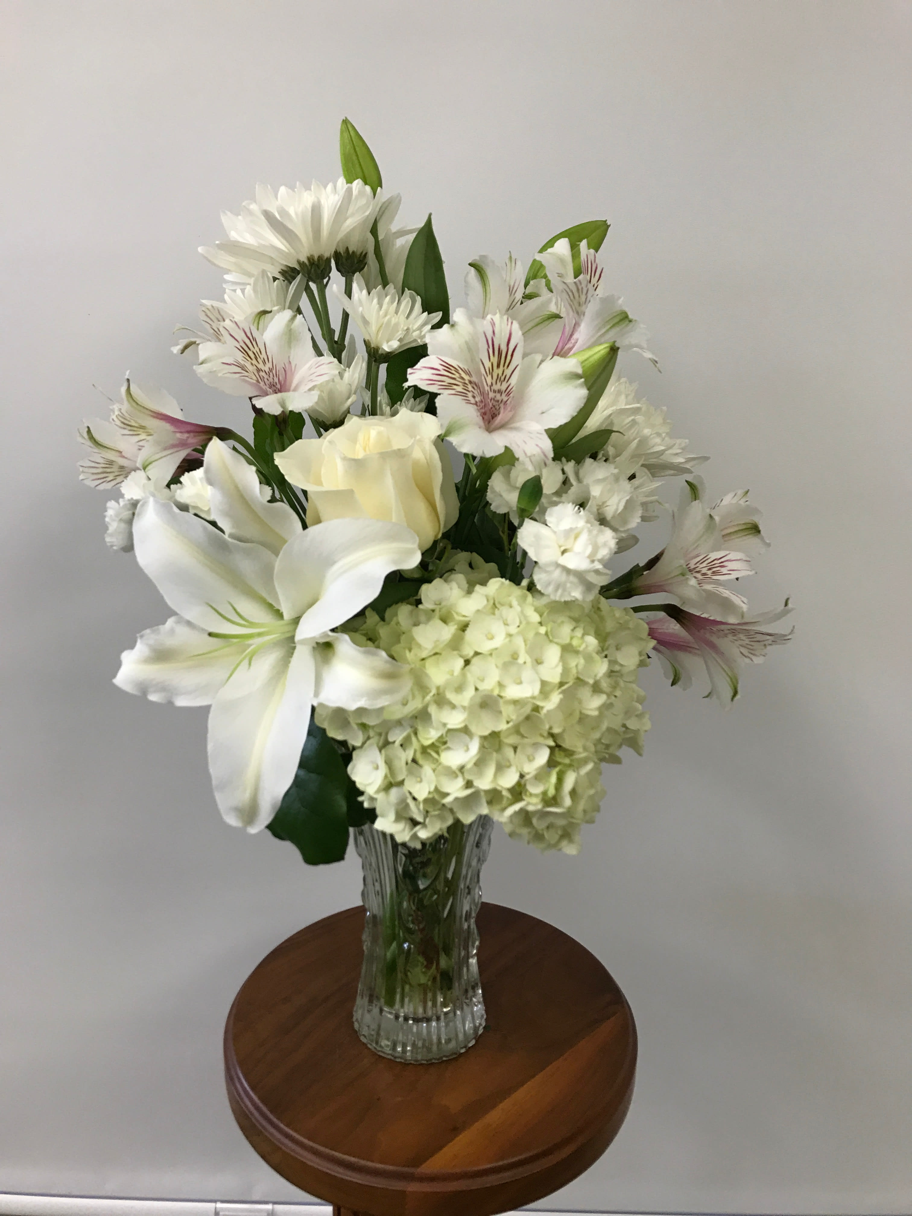  Serene Reflections Bouquet - Your love will be warmly felt with this lovely gift of flowers such as white lilies, hydrangea, and other favorites Tasteful and elegant, it is a beautiful choice. This is an all-around arrangement.  