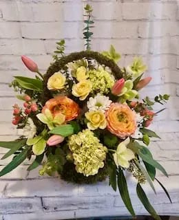 May Basket - This classic May Basket is brimming with gorgeous textures colors and variety of blooms in hues of celery green, burnt peach and bettery yellow.  A beautiful spring classic.  