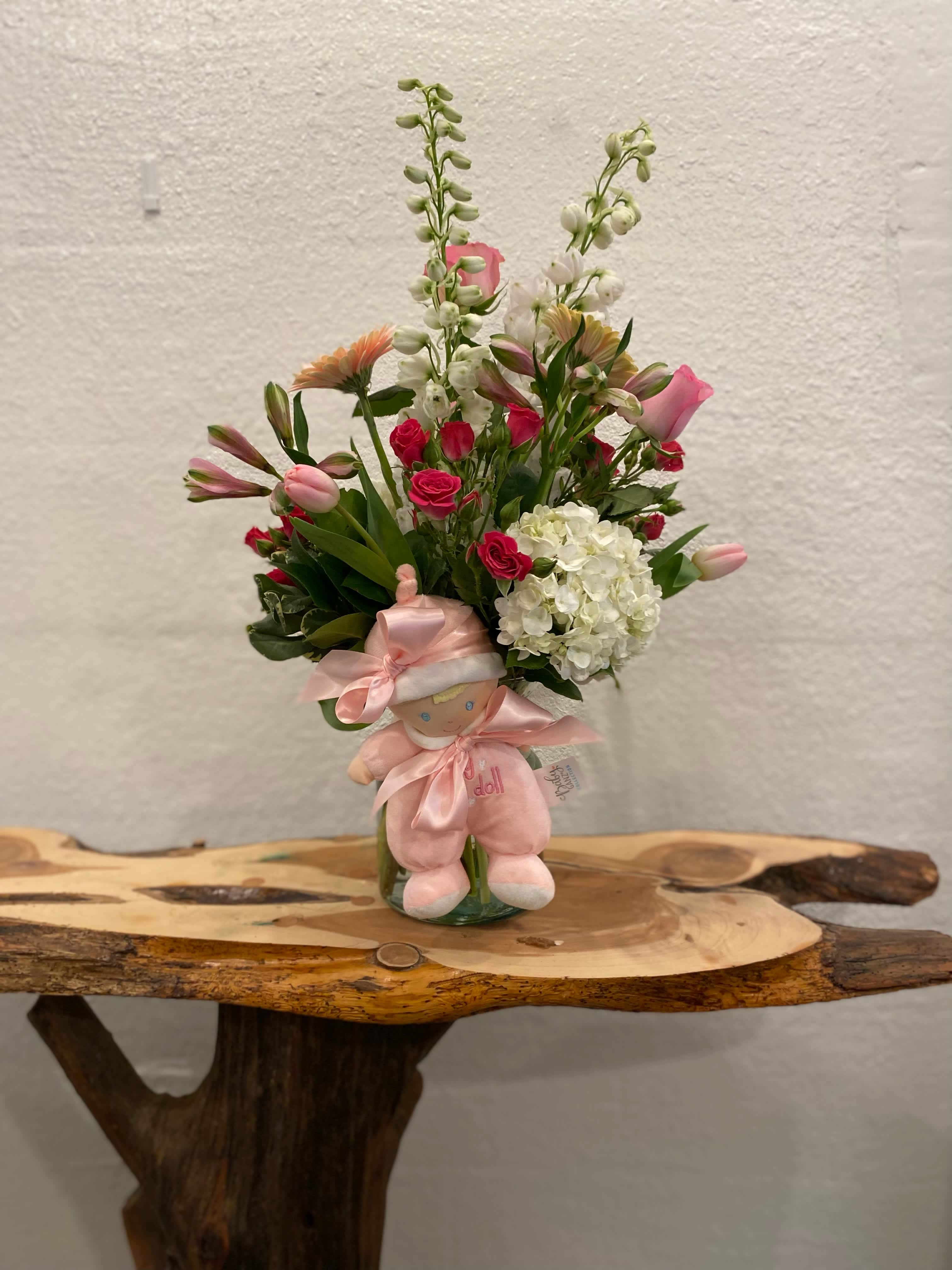 Lovely Baby Girl - Send this beautiful arrangement of pink and white flowers with an adorable pink plush for that new baby in your life.