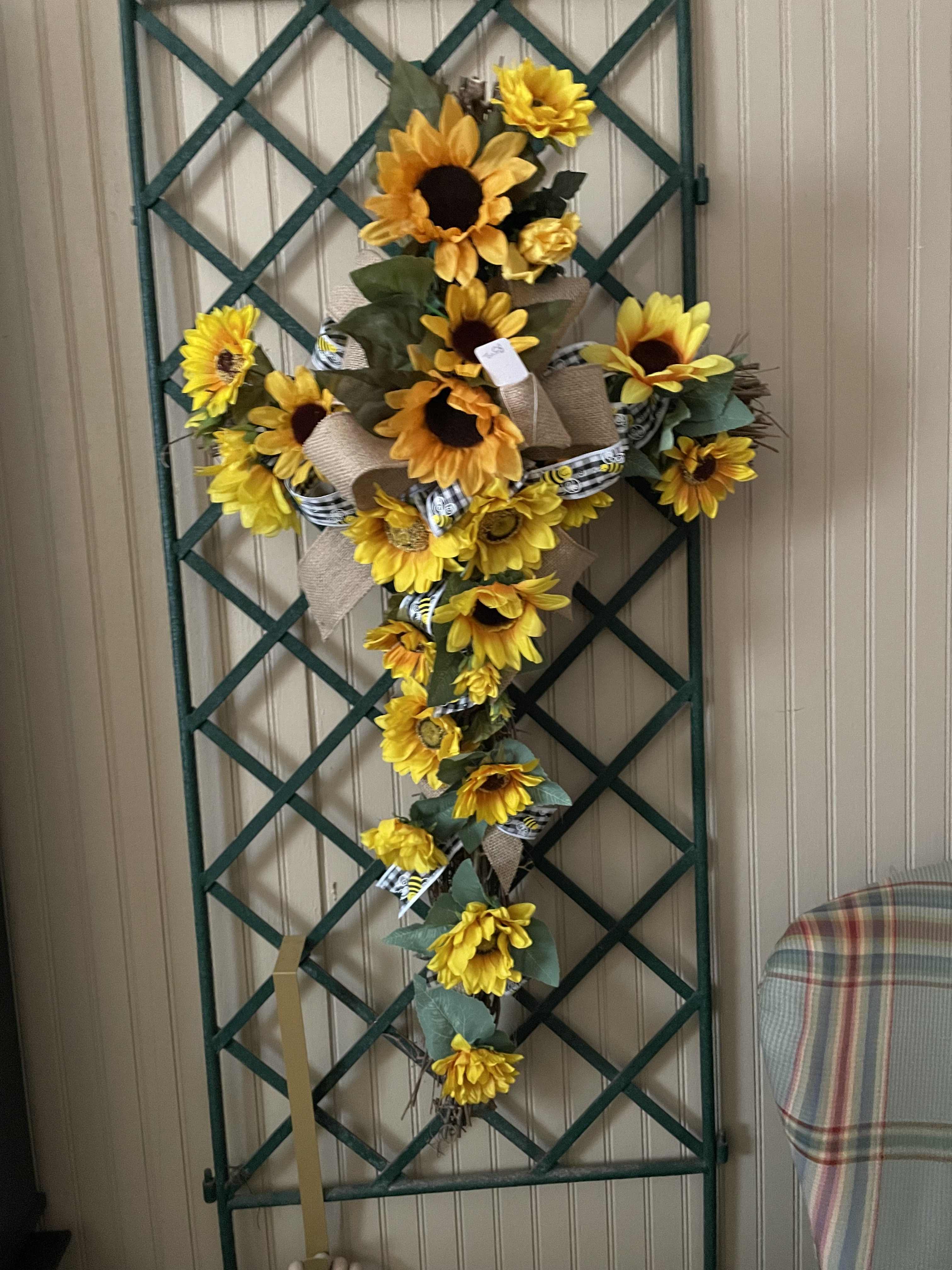 SILK Sunflower Grapevine Cross - A trendy cross surrounded by sunflowers and a trendy ribbons. This is a great piece for the home. Also, these crosses are sent to graveside services to be left or taken home with a loved one.