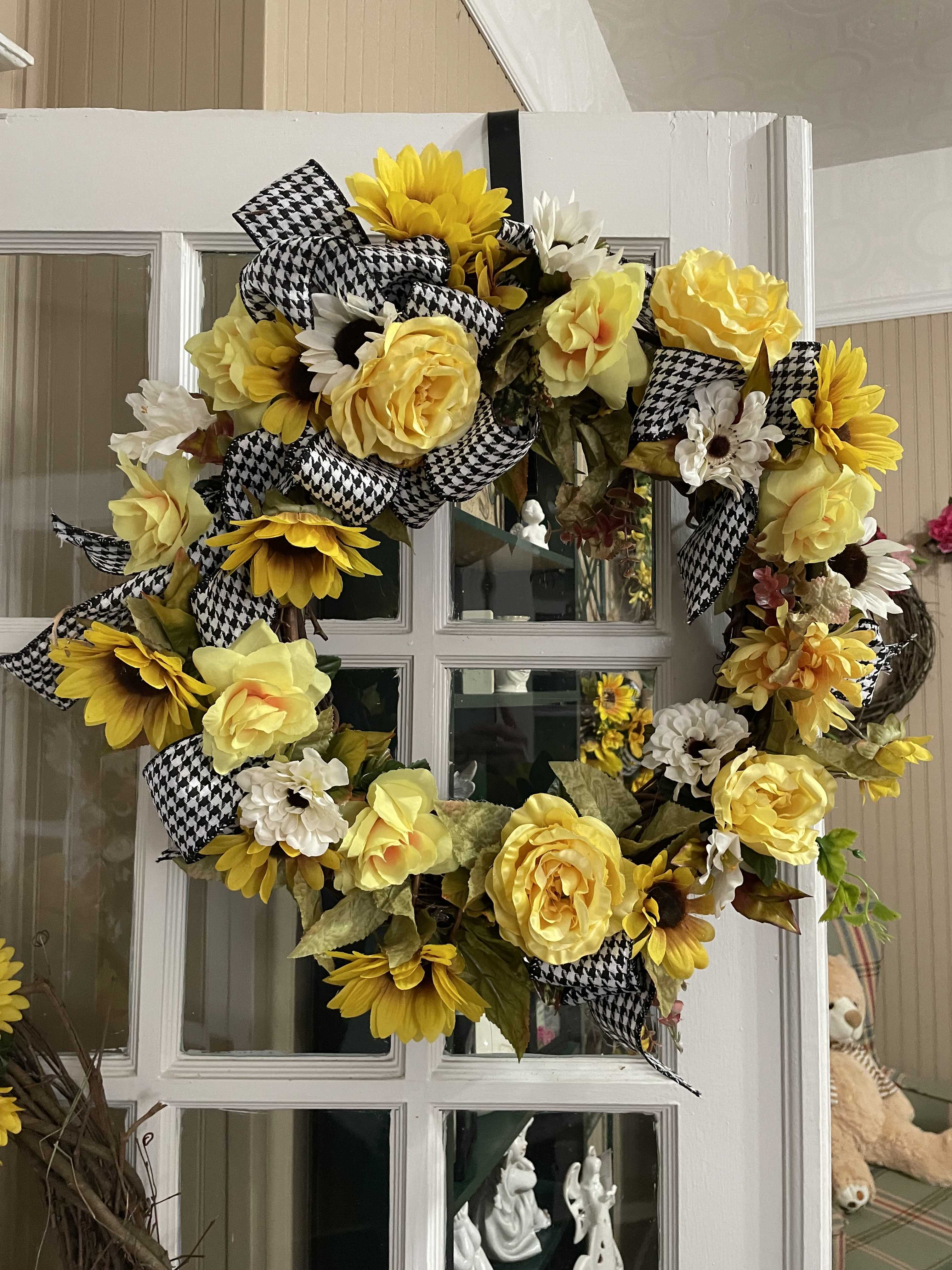 Roses &amp;  Sunflower Silk Grapevine Wreath - Bright and cheery are Sunflowers. Surrounded with yellow roses, ribbons . This is a medium sized grapevine wreath. Put on an easel for funeral  services.