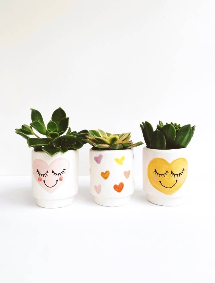 Heart Face Planter Heart Face Planter - Heart Face Planters Measure: 3" x 4" Does not come with drainage hole. Can be used as a drinking vessel. All glazes are non toxic food safe. Handmade locally in Costa Mesa, CA.
