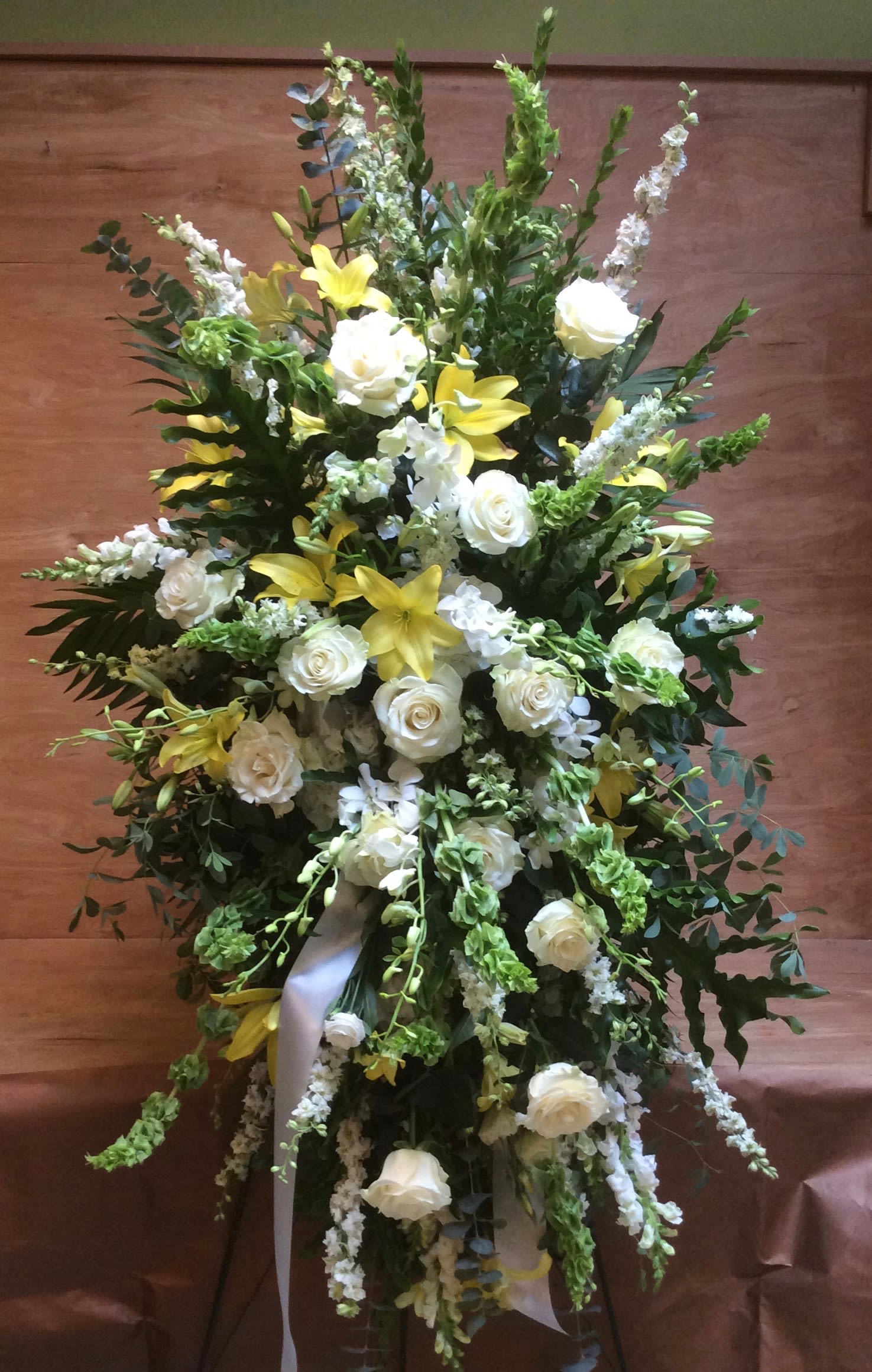 Yellow and white Standing Spray  - To send sympathy flowers is a testament of your love and devotion. This serene standing spray with white and Yellow  lovely flowers will bring comfort . 
