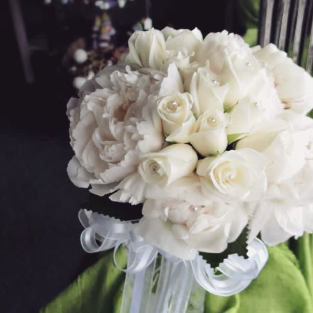 Elegant Bond - This beautiful pure white hand tie bouquet is sure to add a beautiful finish to your wedding. Designed with white roses and peonies. Dimension: 15x12