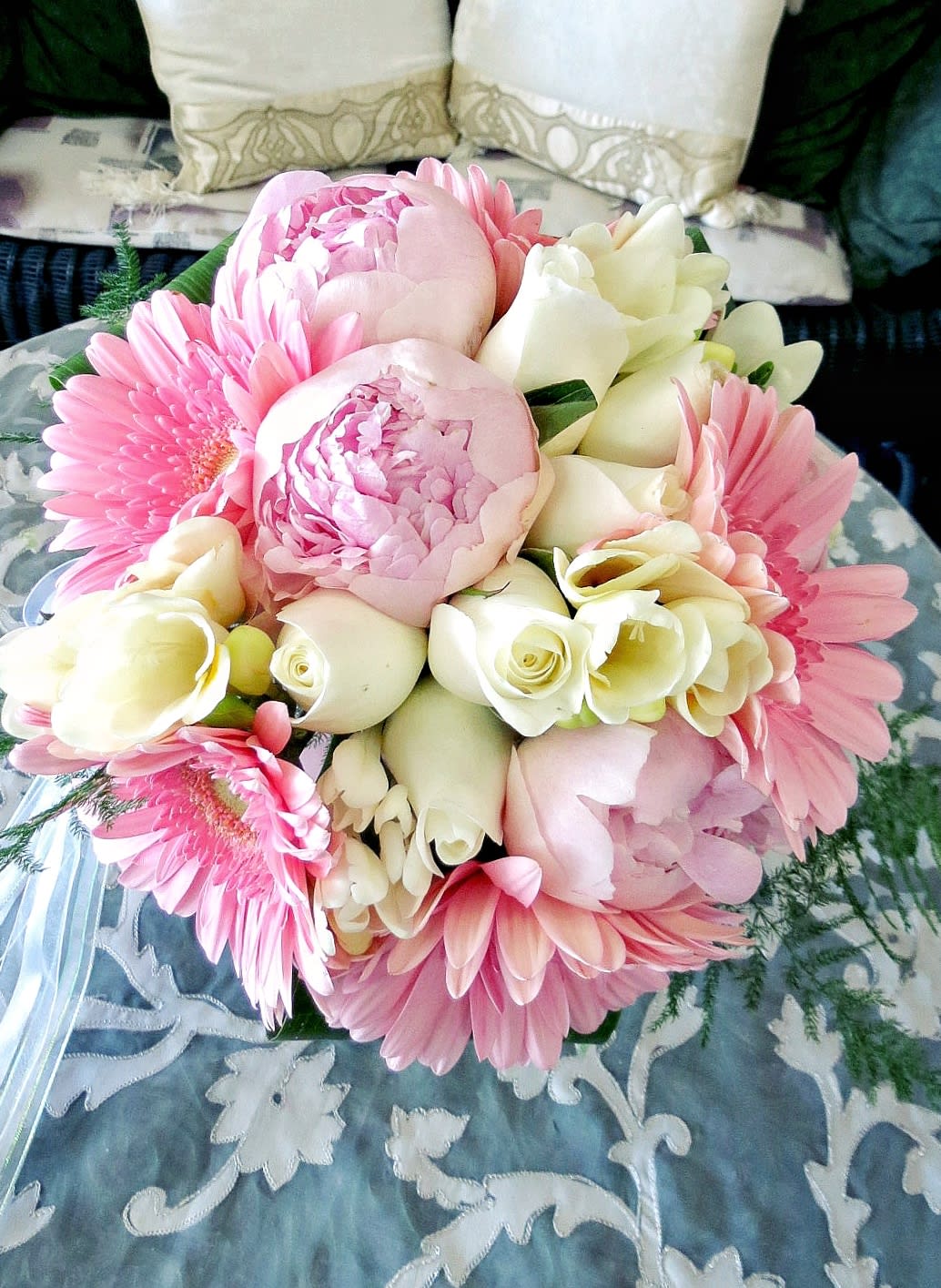 Forever and Always - This beautiful hand tie wedding bouquet is designed using white roses, peonies, freesia, gerbera daises, aspidistra, and plumosa. Dimension: 12x10 