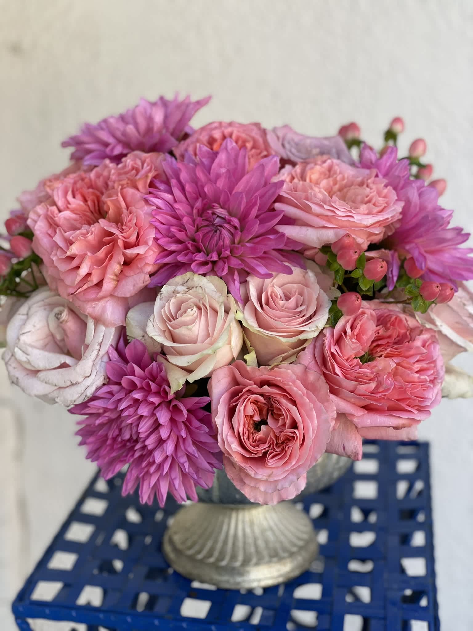 Pretty in Pink - This stunning combination of roses and dahlias creates a compact, modern look that is full of texture and depth. Boasting every hue of pink, this little arrangement is sure to catch the eye and inspire happiness!