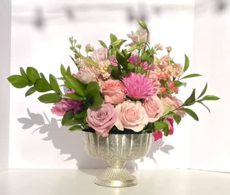 Pink Party - This arrangement bursts out of its container with pink tones from hot to blush. It is full of interesting textures playing with one another, and shapes that will make anyone swoon. The overall combination is one that will illuminate any room, and brighten any day!