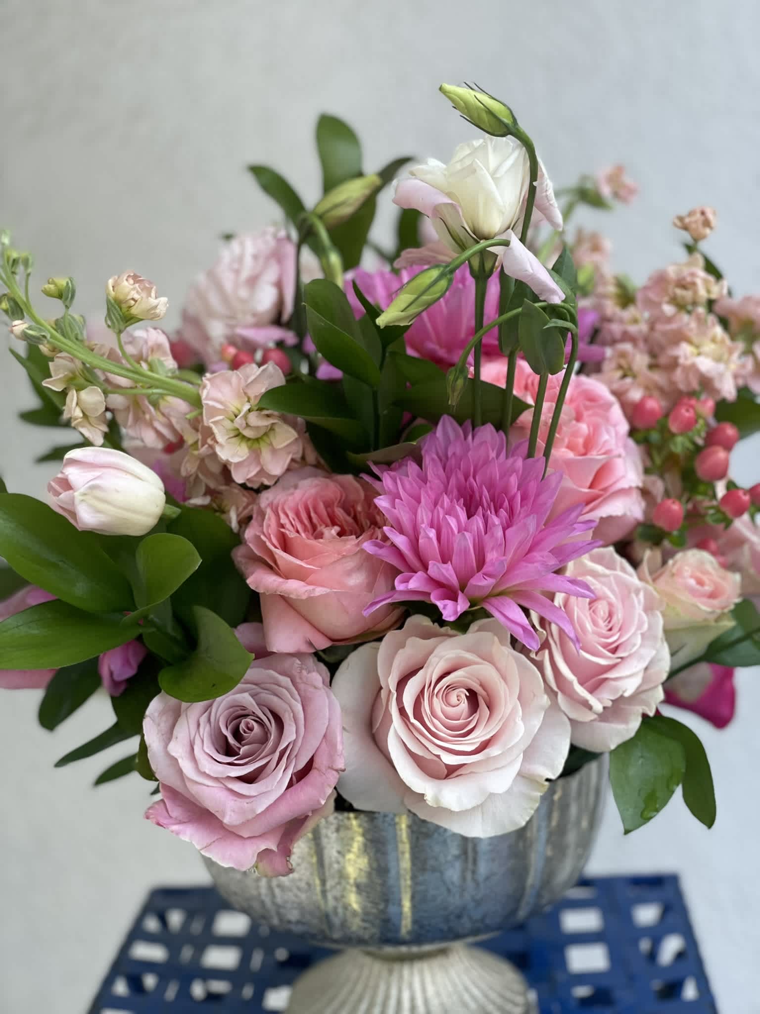 Pink Passion - This arrangement is full of color, texture, and depth. The hues of pinks and peach create a lovely, soft palate that is sure to bring a smile to anyone. The various textures and shapes create a bold and full look that will be the center of attention in any room.