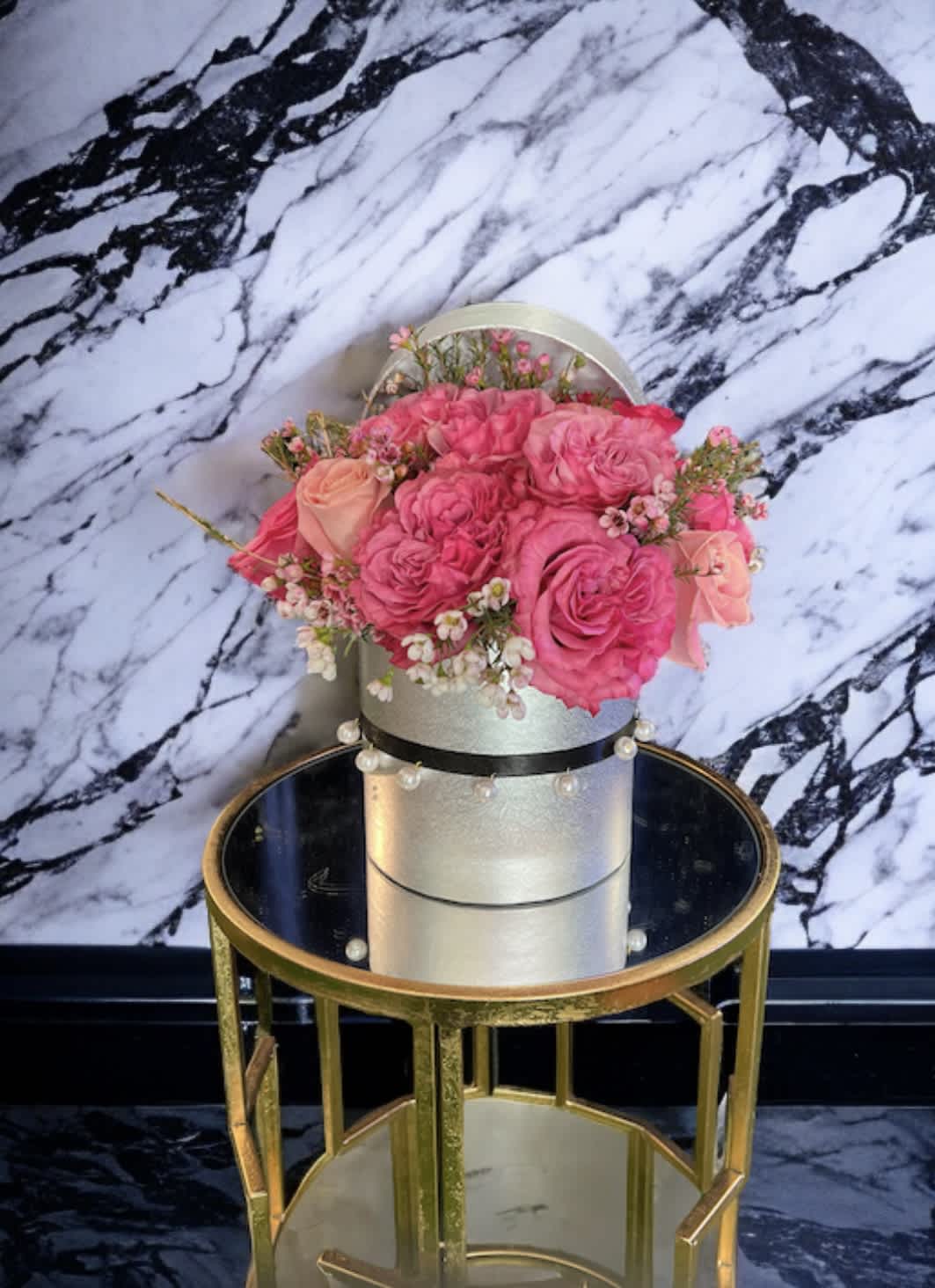 The Little Mermaid - Hat box Size : H 6 * W 6  Box color: silver with decorated with pearl strings Flowers : Pink garden roses mix with pink Wax flowers