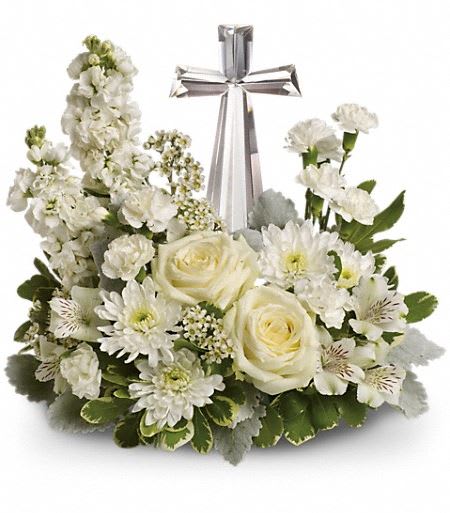 T229-2A Teleflora's Divine Peace Bouquet - An elegant display of faith and divine peace, this beautiful arrangement will comfort the bereaved in a truly thoughtful and respectful way. An exquisite crystal cross is surrounded by a bed of lovely blossoms. It is sure to be appreciated and always remembered. A fragrant mix of pure white blooms - including roses, alstroemeria, stock, carnations and waxflower - is accented with dusty miller and variegated pittosporum around an exclusive Crystal Cross keepsake. Approximately 14 1/2&quot; W x 13 1/2&quot; H 