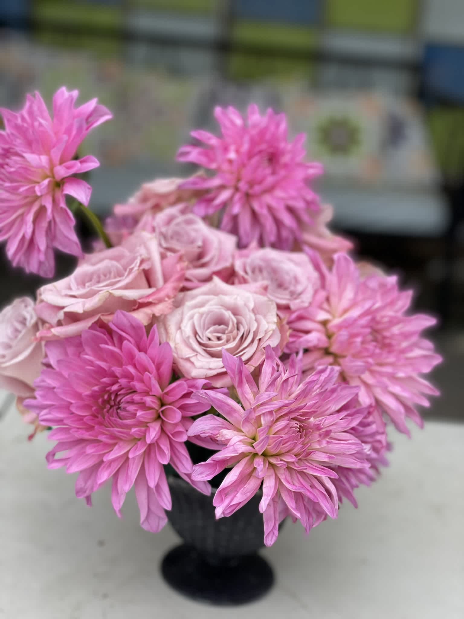 Happy - This compact composition of Roses and Dahlias boasts a bold look, shining brightly in hot pink and pink. This arrangement is defined by the wild texture and deep color of the Dahlias, and grounded in the elegant round pink roses. It is by definition a &quot;happy&quot; for anyone who receives it.