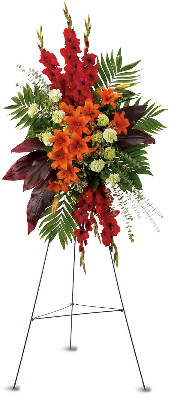 A NEW SUNRISE SPRAY - While the loved one is no longer present, there are happy times that will never be forgotten. This radiant spray of red and orange flowers will be a lovely reminder.  The stunning arrangement includes orange Asiatic lilies, red gladioli, green carnations, peach hypericum, emerald palm and red ti leaves, accented with assorted greenery.