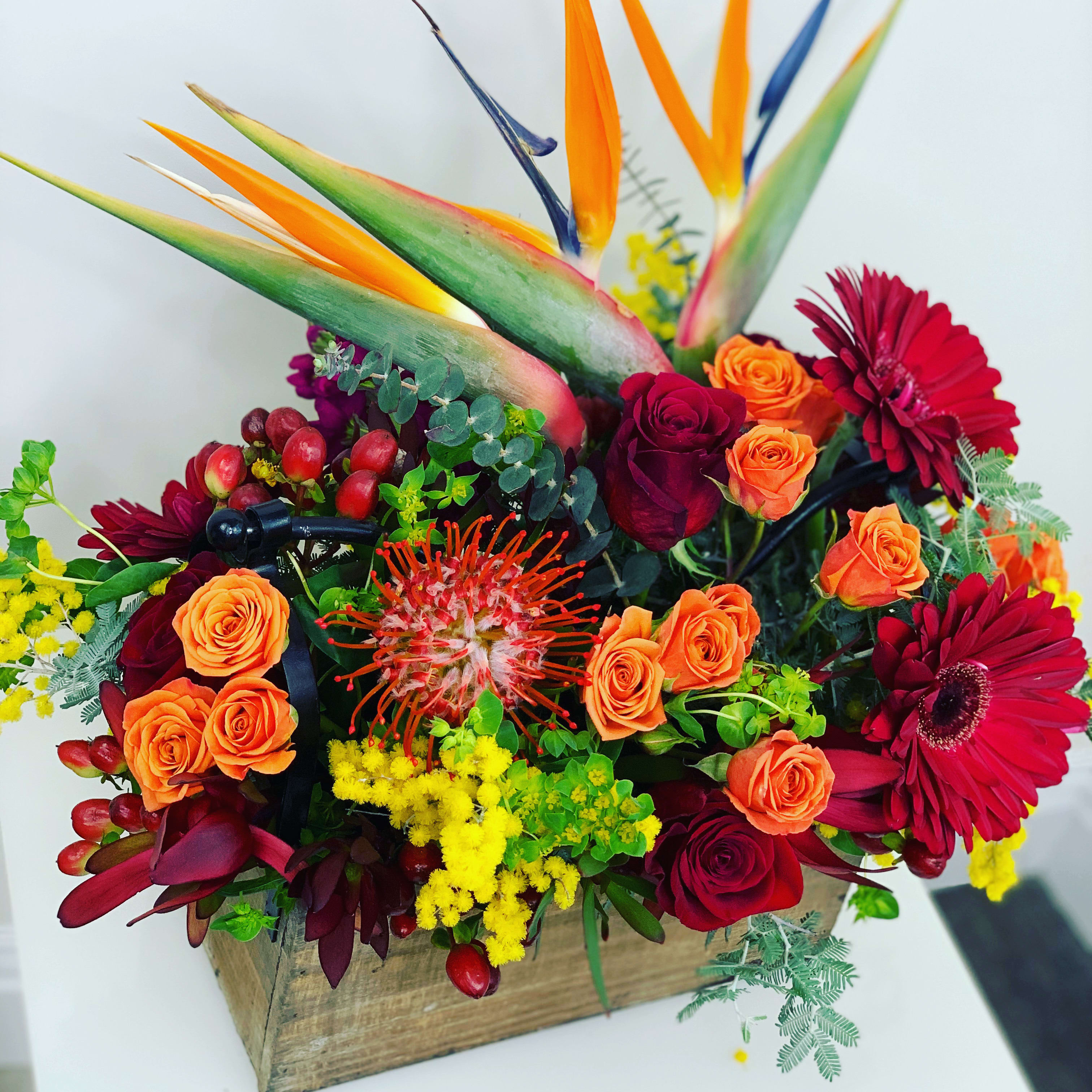 Explosion of Joy  - This box is full of fresh flowers in style. It will bring joy to anyone.   In some instances, our photo may represent an overall theme or look and include a one-of-a-kind vase which cannot be exactly replicated.  Although the actual bouquet may not precisely match the photo, its temperament will. Occasionally, substitutions of flowers and/or containers happen due to weather, seasonality and market conditions which may affect availability. If this is the case with the gift you’ve selected, we will ensure that the style, theme and color scheme of your arrangement is preserved and will only substitute items of equal value or higher value.  DELIVERY TIMES ARE USUALLY BETWEEN 2:30 PM THROUGH 6:30PM ON THE DAY OF DELIVERY. FOR SAME DAY ORDERS, PLEASE GIVE US AT LEAST 6 HOURS TO PROCESS AND DELIVER THE FLOWERS AS PRIOR ORDERS WILL BE PRIORITIZED. MORNING DELIVERY REQUESTS AND SPECIFIC TIME REQUESTS WILL BE AN ADDITIONAL $15 FOR A CONVENIENCE FEE CHARGE. OTHERWISE, SPECIFIC TIMES ARE ACKNOWLEDGED AND WE WILL DO OUR BEST TO ACCOMMODATE, HOWEVER WE CANNOT GUARANTEE ON TIME DELIVERY. GATE CODES ARE MANDATORY FOR OUR DELIVERY DRIVERS TO BE ABLE TO ENTER RESIDENTIAL OR COMMERCIAL BUILDINGS. IF YOU DON’T KNOW THE GATE CODE FOR A DELIVERY, PLEASE CONTACT THE RECIPIENT AND PROVIDE US WITH IT OR OUR DRIVER CAN CONTACT THE RECIPIENT BEFORE BEGINNING A DELIVERY ROUTE TO OBTAIN THE CODE. OUR POLICY STATES THAT DRIVERS WILL ONLY WAIT FIVE MINUTES OUTSIDE THE GATE FOR A CALLBACK. IF A DRIVER HAS TO LEAVE A PROPERTY, THE DELIVERY IS REASSIGNED FOR THE NEXT DAY AND MAY CHARGE AN ADDITIONAL DELIVERY FEE. THANK YOU FOR YOUR BUSINESS.