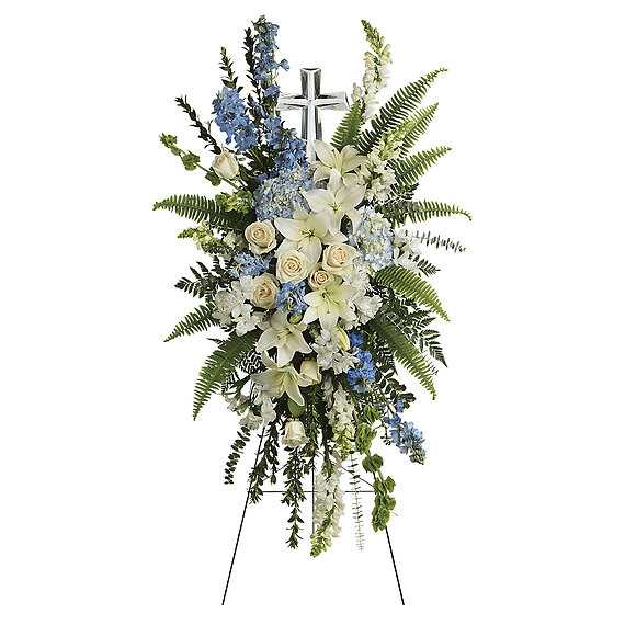 ETERNAL GRACE SPRAY - Celebrate the eternal grace of a life well lived with this dramatic spray of peaceful white and blue blooms, crowned with a large crystal cross keepsake.  
