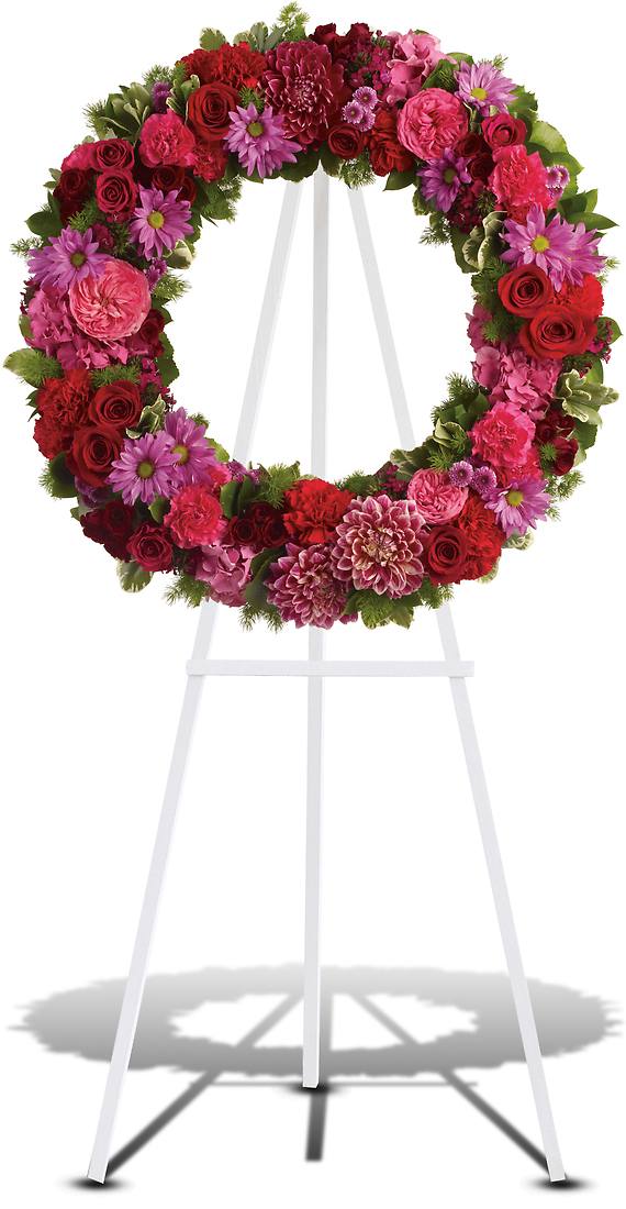 INFINITE LOVE INFINITE LOVE - Reminiscent of the rich jewel tones of an exquisite stained glass window, this lovely floral testament to the circle of life and love evokes beautiful memories even during the most difficult times. A standing wreath of stunning flowers such as hot pink roses and carnations, red roses, burgundy dahlias, dark pink Sweet William, lavender chrysanthemums and fresh greens.