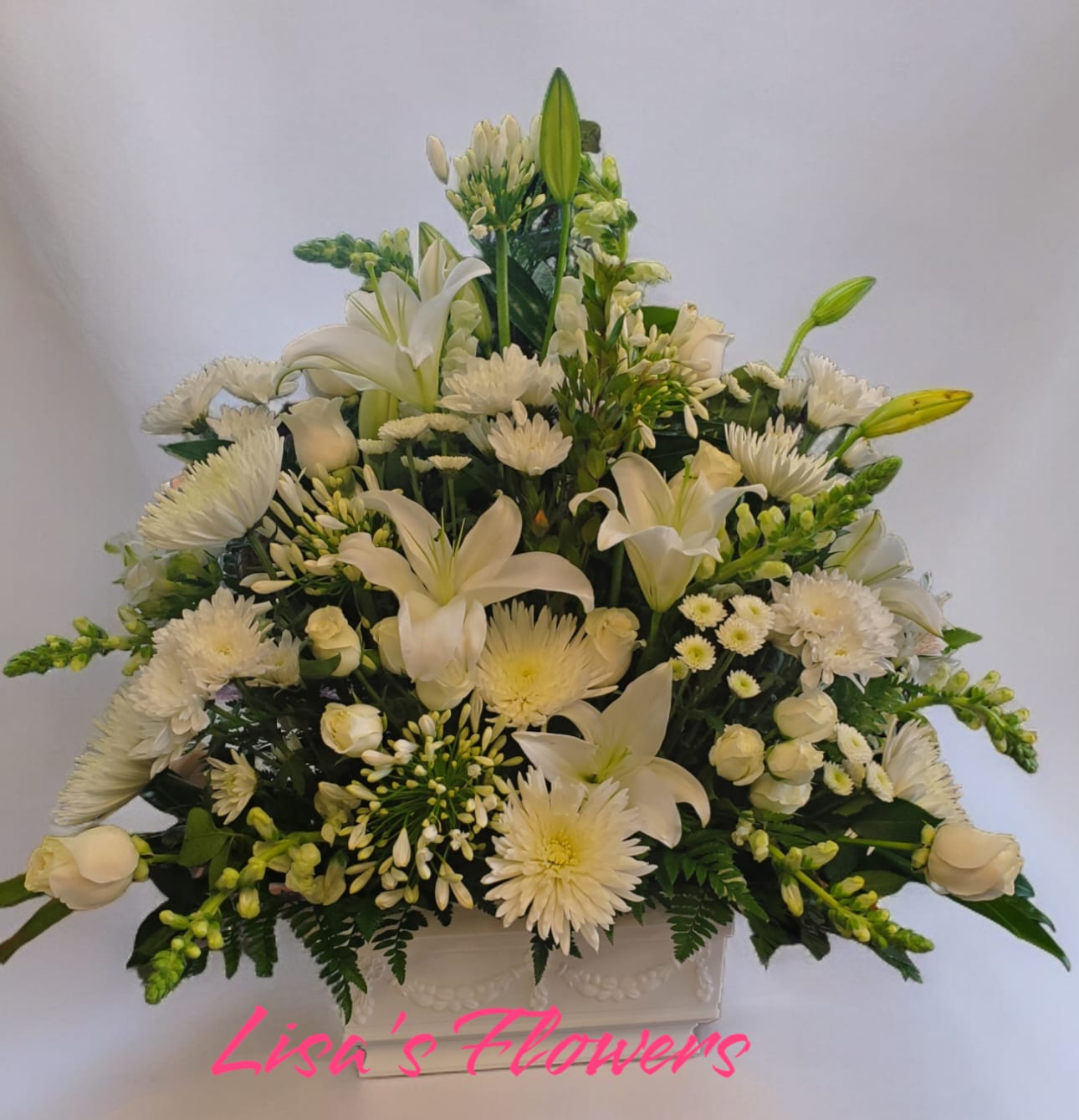 Grace Grace - Beautiful all white sympathy arrangement features roses and lilies.