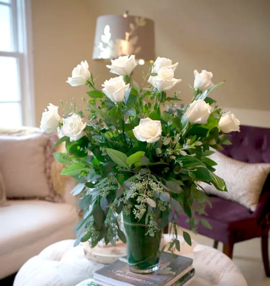 Classic Dozen Roses in White  - A modern and grand take on the timeless white rose bouquet.  Premium long stem white roses arranged in a glass cylinder vase, surrounded by greenery of seeded eucalyptus, and lemon leaf. Send to someone you care about to say I'm sorry, thinking of you, or wish we could be with there.   Arrangement is approximately 24&quot; tall and 14&quot; wide.   COVID NOTICE: Due to an international shortage of flowers and vases and floral supply chain issues, it may be necessary to substitute similar flowers and the vase used in this design. We always strive to create a design as close as possible to the design shown. If you have any questions regarding these changes, please call and talk to a team member before placing your order, (703) 779-3530.