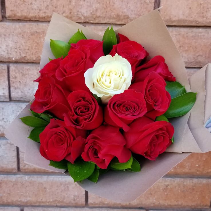 My One &amp; Only Rose Bouquet - A single creamy White Rose is surrounded by twelve Red Roses. A message of love unfurls with every petal. This bouquet is hand arranged by our designers and available for pickup only.  Please Note: This bouquet does not include a vase and the rose stems require a sharp fresh cut before placing your bouquet in water. We recommend placing your bouquet in fresh water within an hour of picking it up from our store. This process will ensure extended flower's life span.