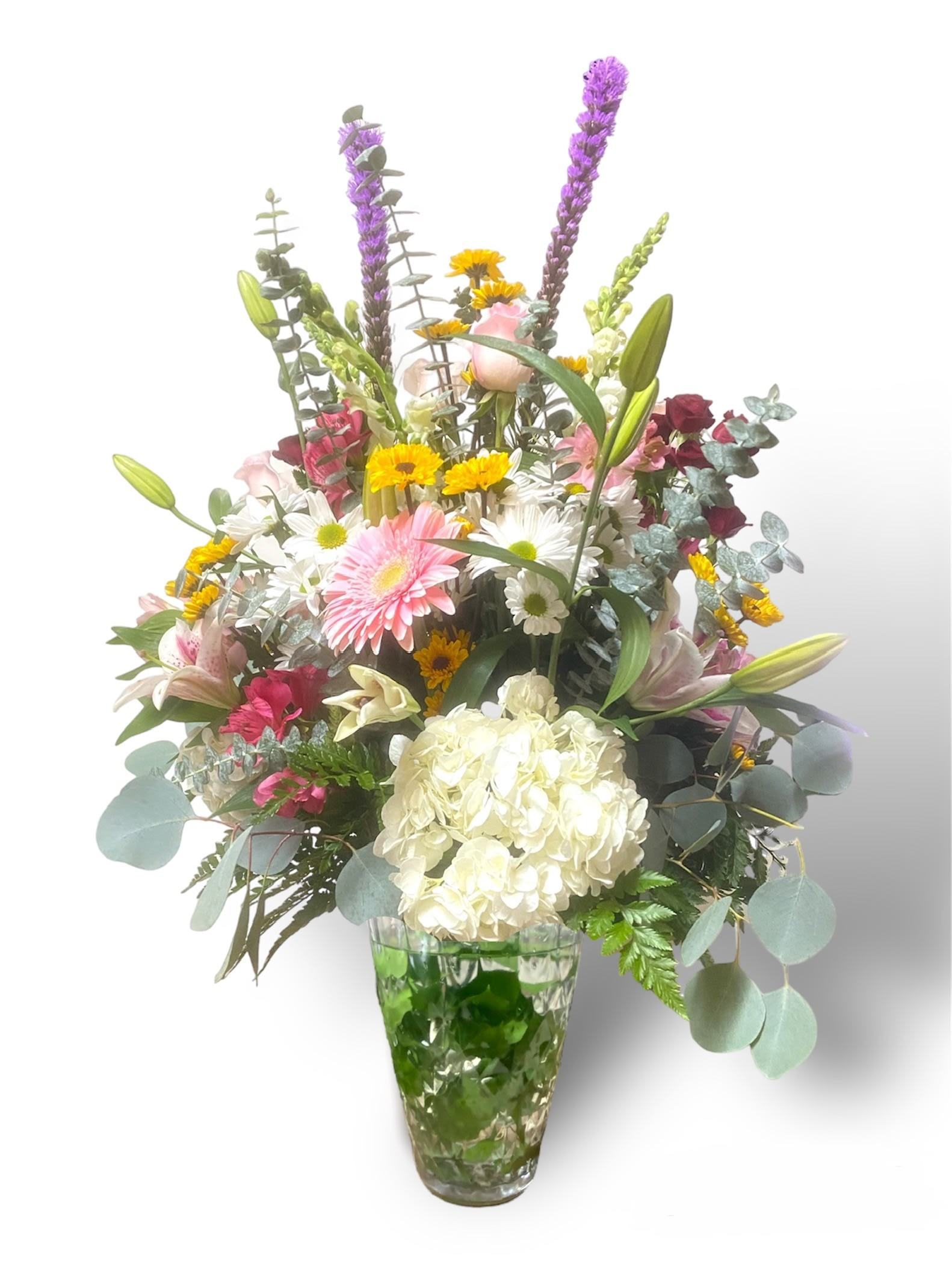 Grand Garden - This beautiful arrangement is like walking through the grand Garden of an old estate, beautiful assorted flowers, and lush foliage, arranged in a beautiful glass vase