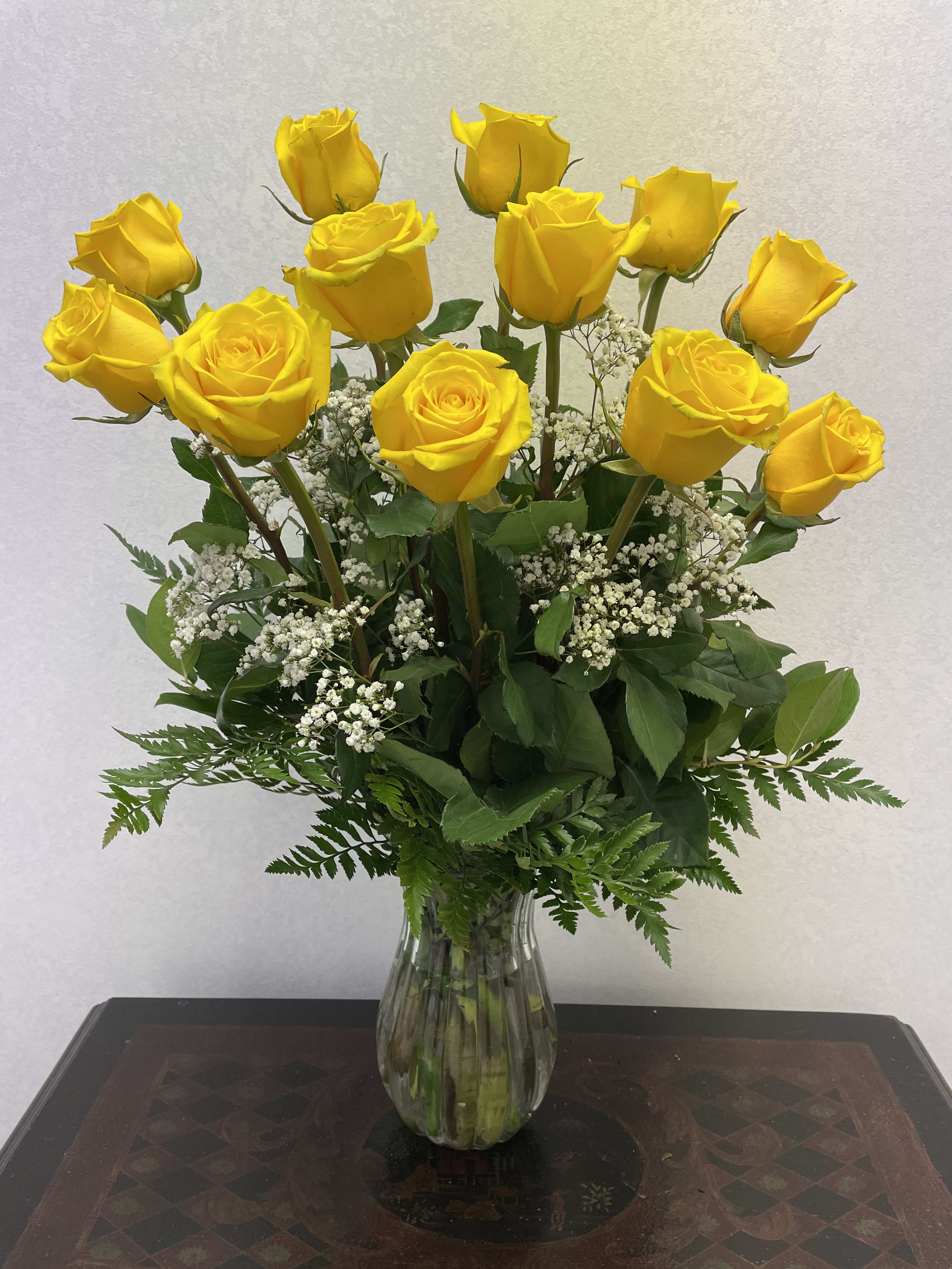 You're My Sunshine Yellow Rose Bouquet  - Sunny yellow roses will brighten anyone's day. This lively bouquet is arranged in a clear glass vase with mixed greens and baby's breath or limonium.