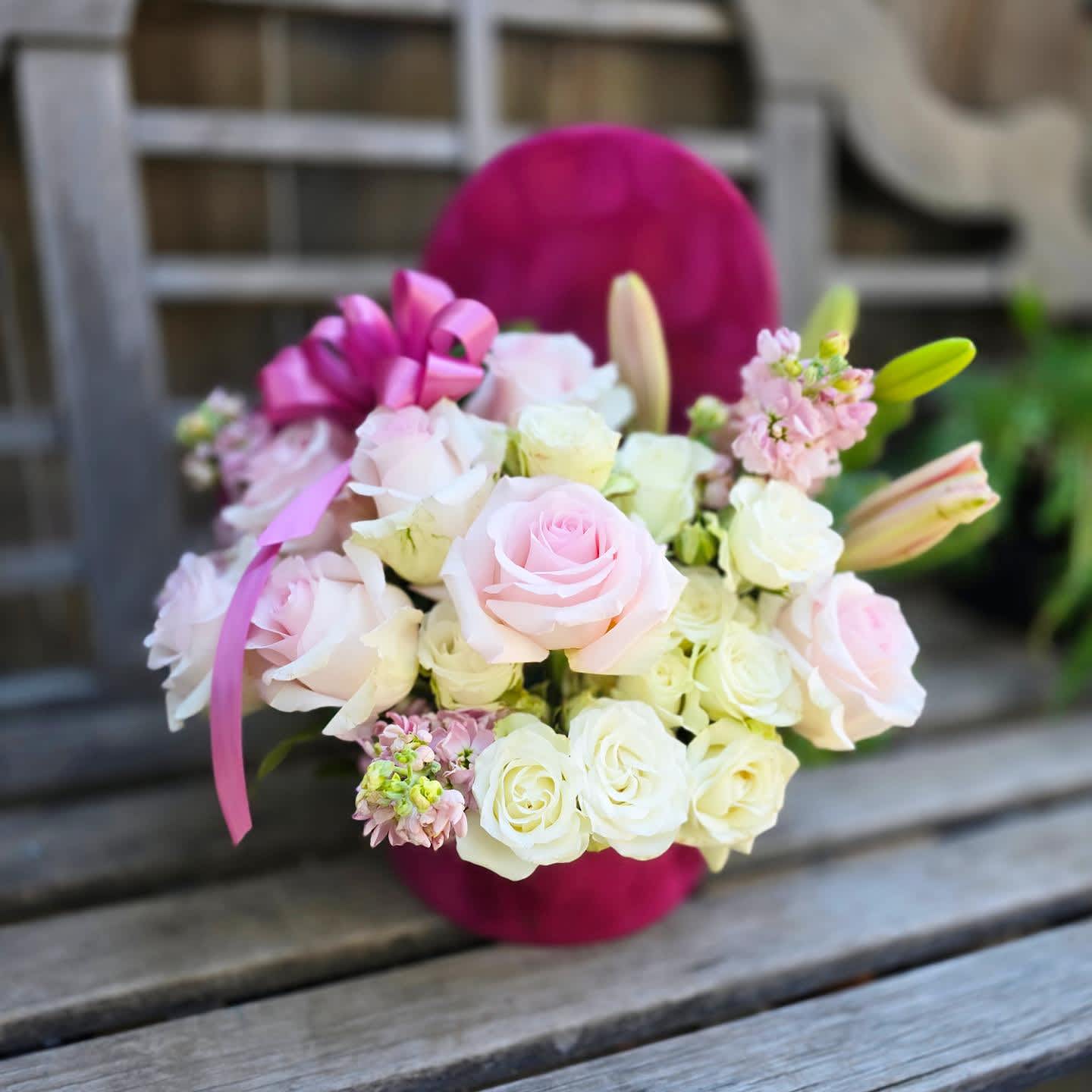 Mullberry cloud - &quot;The Mulberry Cloud&quot; is a delectable assortment of pink roses, white spray roses, and pink lily in a deep velvet Mulberry colored cylinder box. We offer this Arrangement is 3 sizes, the diameter of the box as well as the number of florals increases with each size.  Our standard size is designed around 7 roses, with supporting florals  Our Deluxe size is designed around 10 roses in a Medium sized box with an increase of supporting florals Our Premium size is designed around 1 dozen roses, in a large box with a sizable increase of supporting florals.  Appropriate substitutions for this arrangement would be florals in shades of light pinks or white Including: white or light pink lisianthus, white stock, white lily, light pink spray rose, light pink or white hydrangea, white or light pink Ranunculus. Container substitutions may include a similarly toned berry shade box. If substitutions are necessary our florist will select the most beautiful florals that match the look and feel of this arrangement.