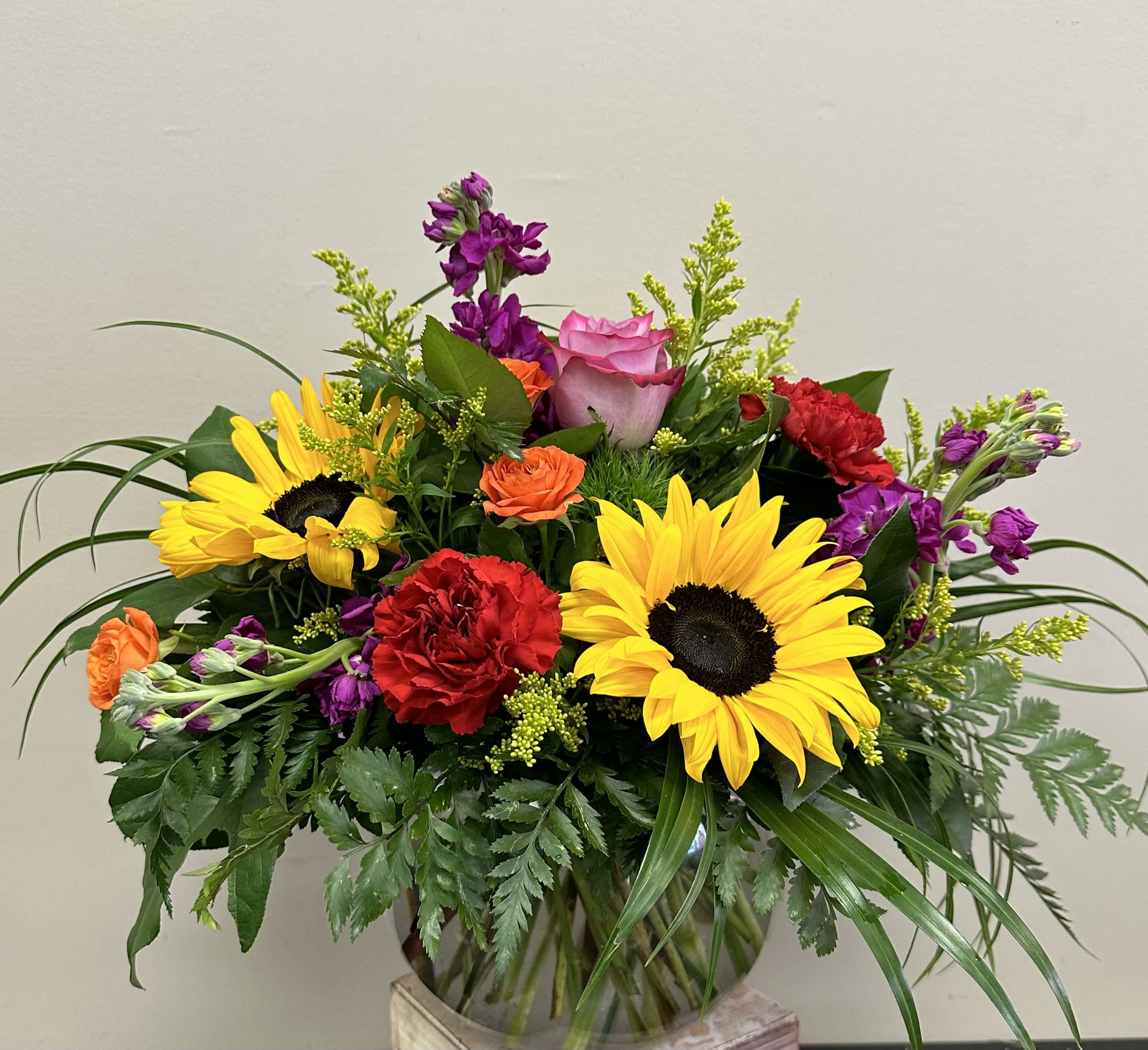 My Garden - This garden style arrangement includes sunflowers, roses, stock, and seasonal blooms. This is a great gift for a birthday or Just Because. APPROXIMATE DIMENSIONS: 12&quot; D x 12&quot; H