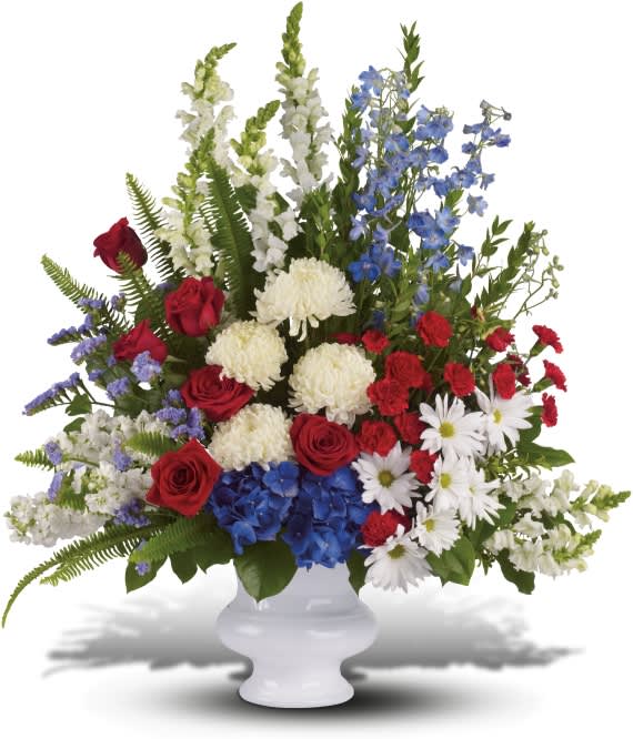 WITH DISTINCTION WITH DISTINCTION - A classic all-American display of patriotic red, white and blue flowers pays tribute to the memory of one who proudly served his country, and is a testament to hope, freedom and strength. This bold display in a classic white urn - including flowers such as red roses and carnations, white stock, snapdragons and chrysanthemums, blue hydrangea and delphinium - appropriately honors the beloved veteran or patriot.