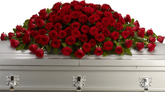 GREATEST LOVE CASKET SPRAY - Express your love and devotion with the traditional elegance of this stunning red rose casket spray. Ideal for a full couch or closed casket service, the impressive display features a generous array of bold, beautiful blooms.  