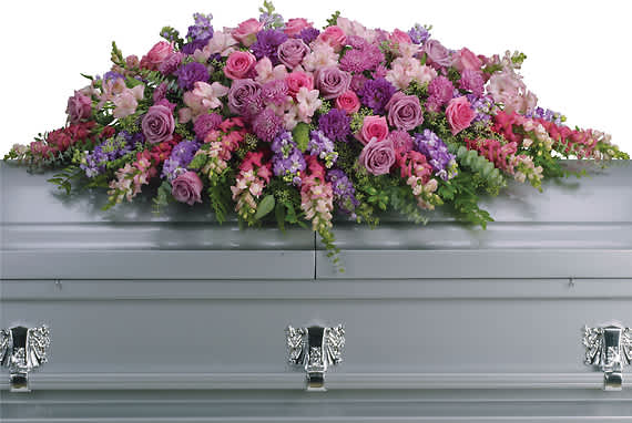 LAVENDER TRIBUTE CASKET SPRAY - Honor her femininity and generous spirit with a blanket of sweetly scented lavender, pink and purple flowers that create a magnificent final tribute, sincerely expressing devotion and love.  