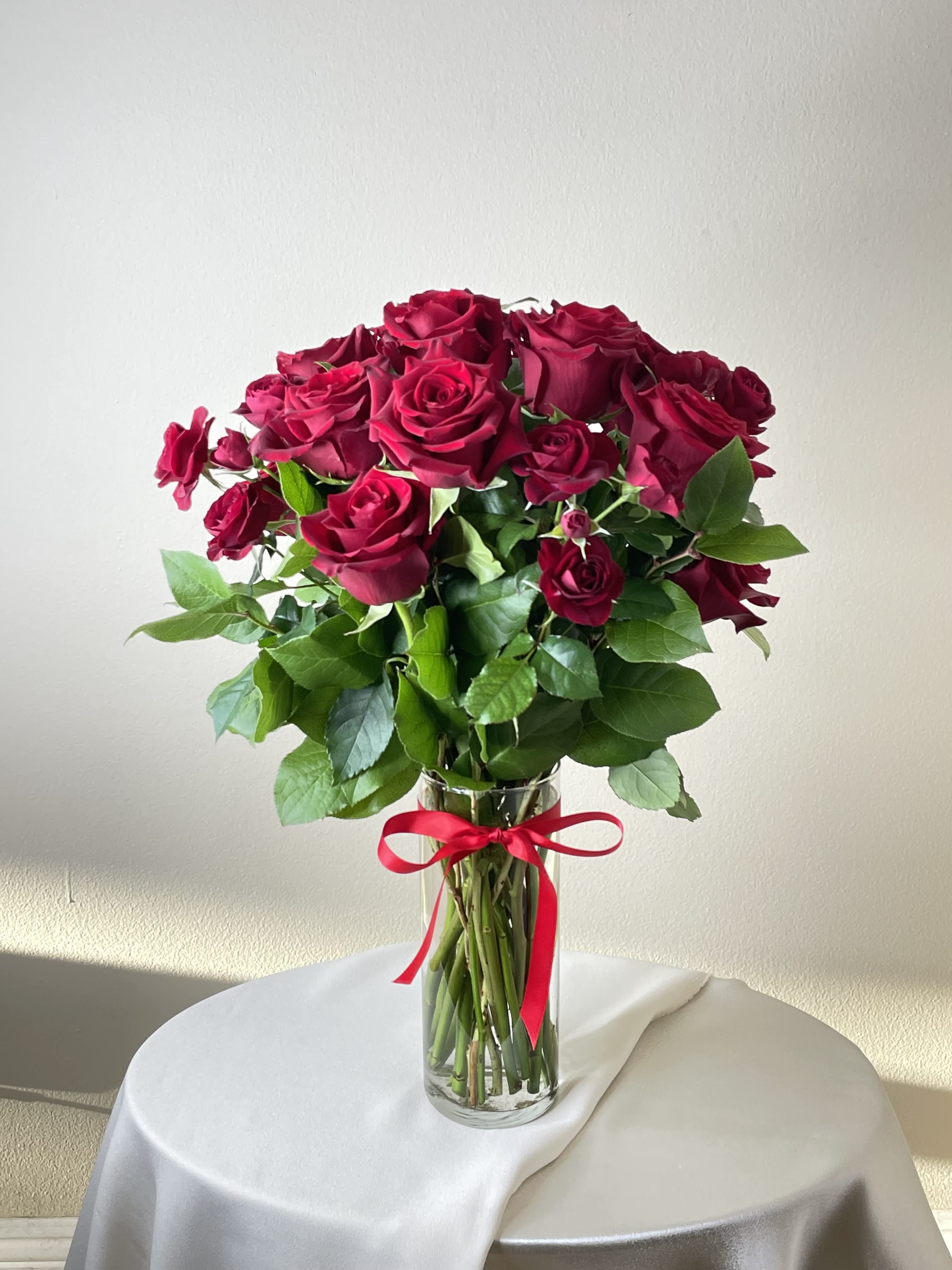 One Dozen Red Roses - One dozen red roses enhaned with red spray roses with greenery 	  Orientation: All-Around As Shown: IVF104 