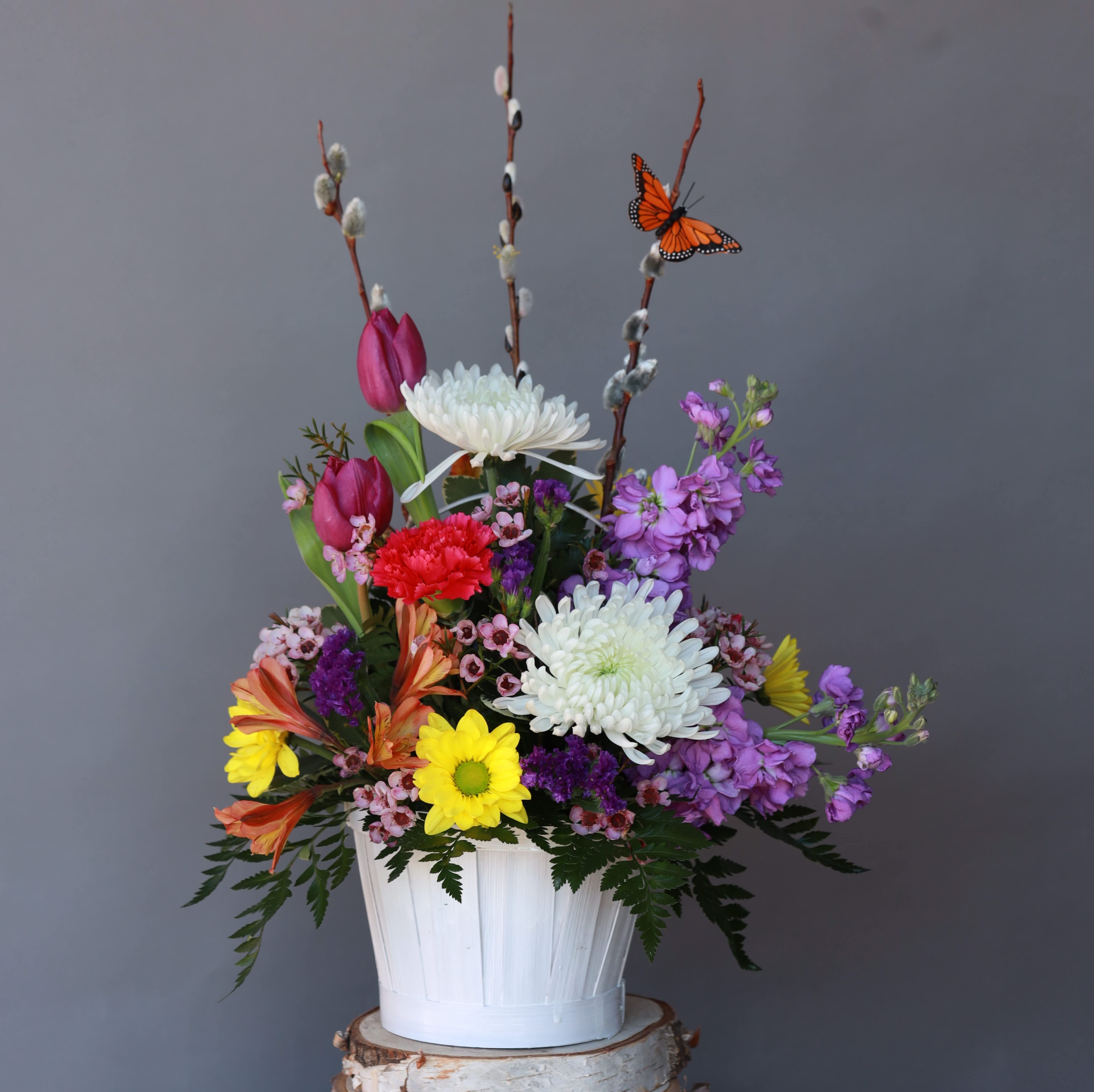 Rainbow Farewell - Honor cherished memories with a vibrant display of hope and love. The Rainbow Farewell is a sympathy arrangement bursting with bright, beautiful blooms in every color of the rainbow. It expresses joy for a life well-lived and offers comfort during a difficult time.